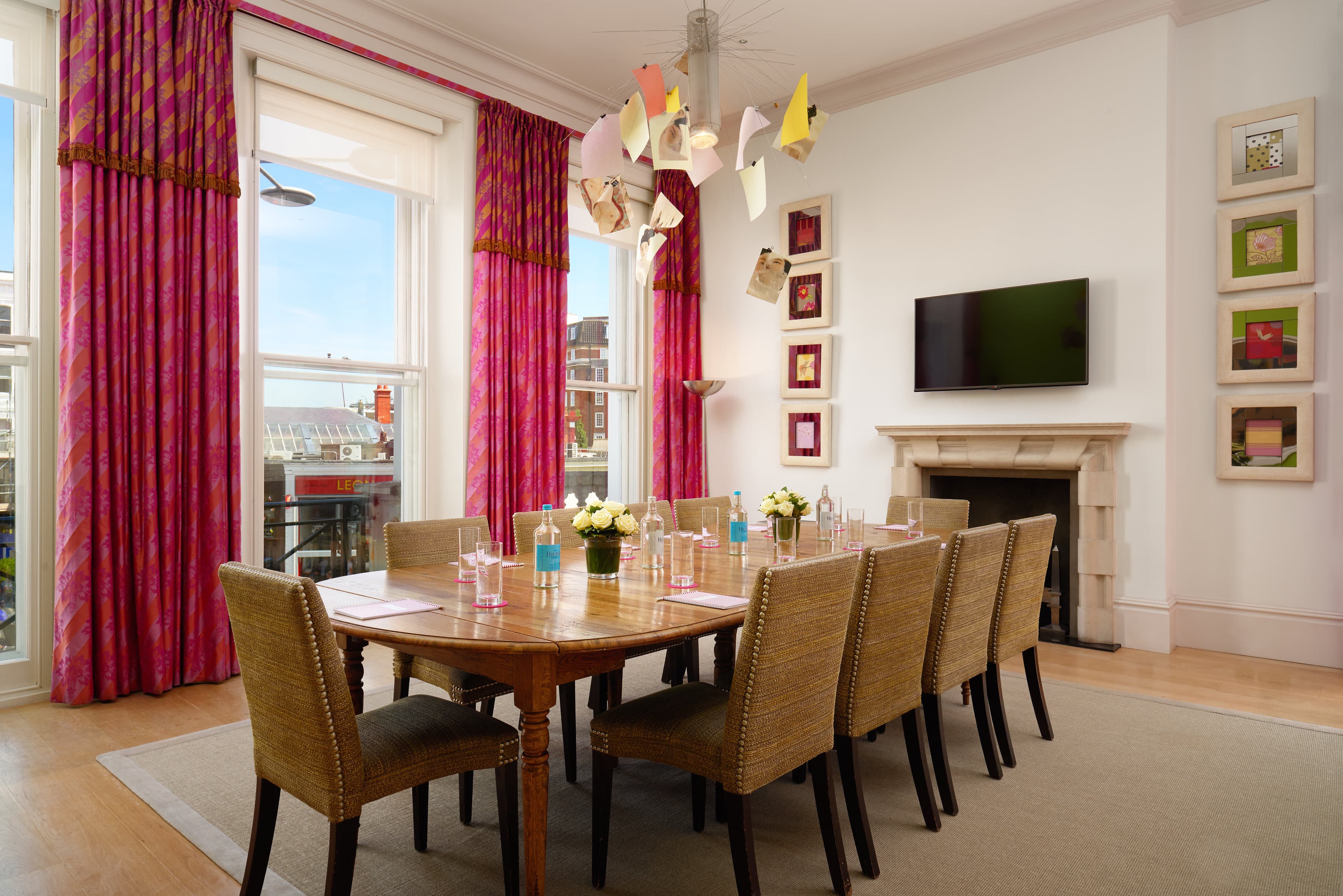 Meeting room at The Pelham Hotel with a large wooden table for collaborative events.