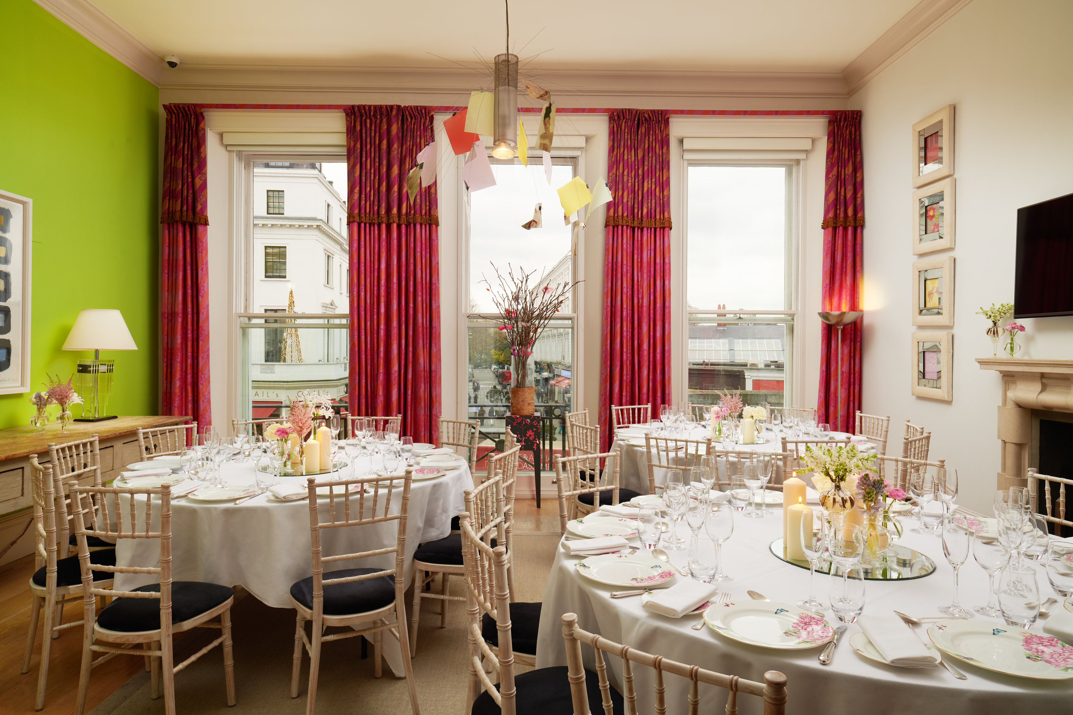 Elegant event space at The Pelham Hotel with round tables and natural light.