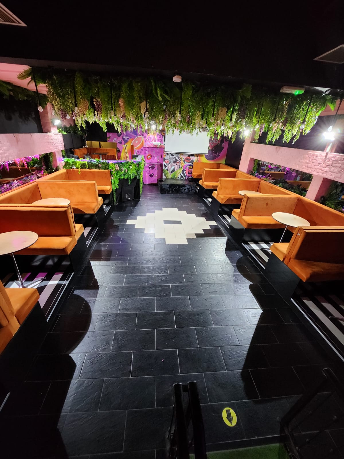 Vibrant BUNA Lounge event space with cozy orange booths for social gatherings.