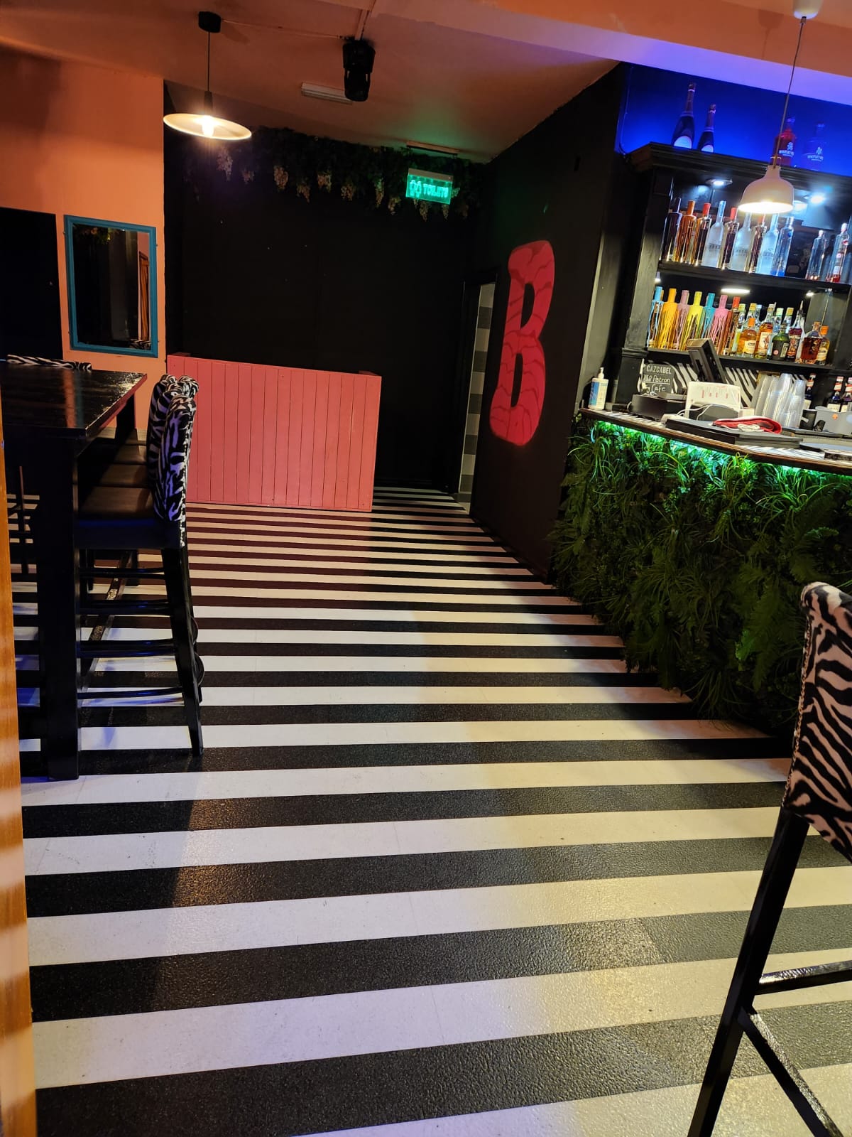 Vibrant BUNA Lounge with striped floor, ideal for events and themed parties.