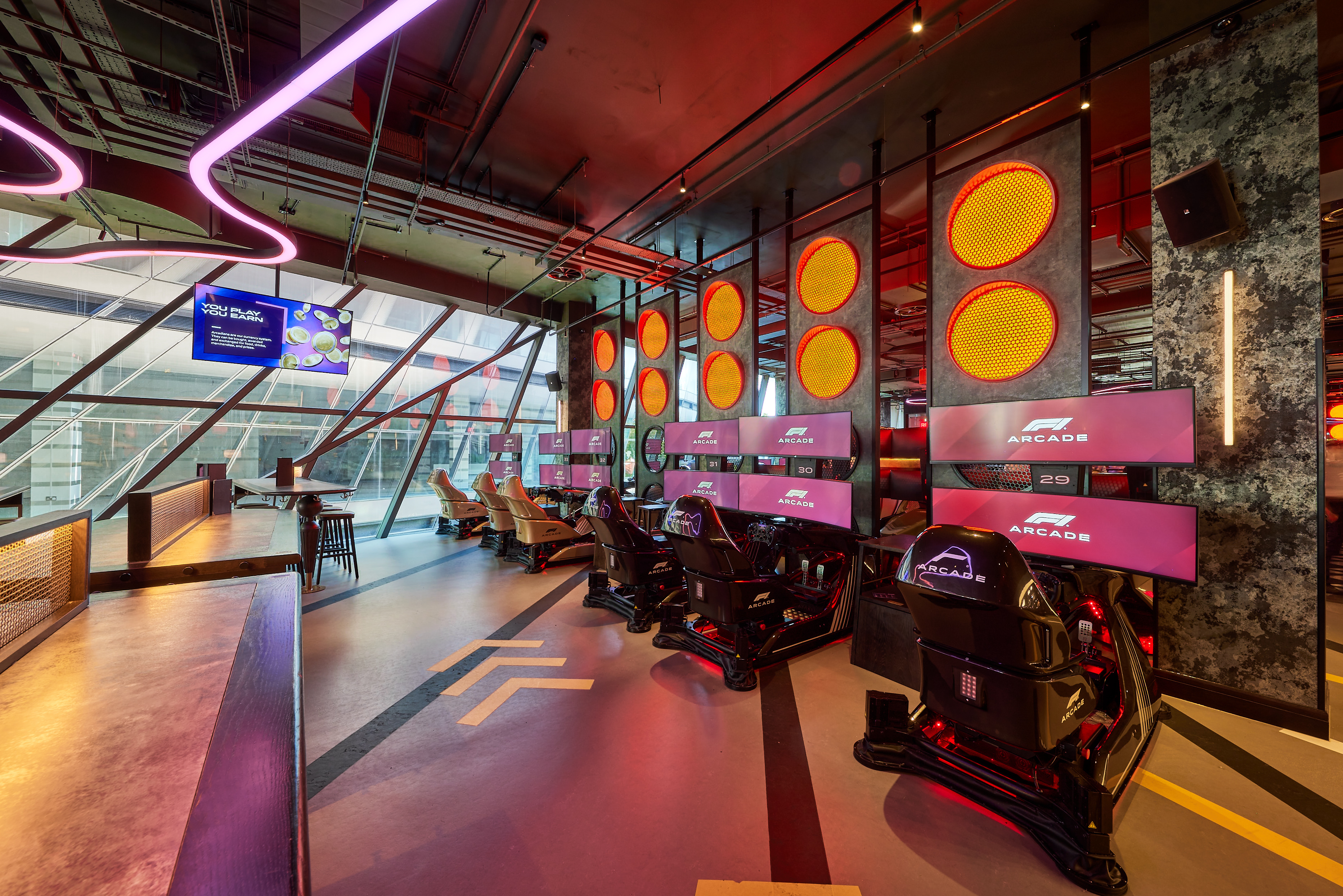 Modern event space with racing simulators for team-building and entertainment activities.