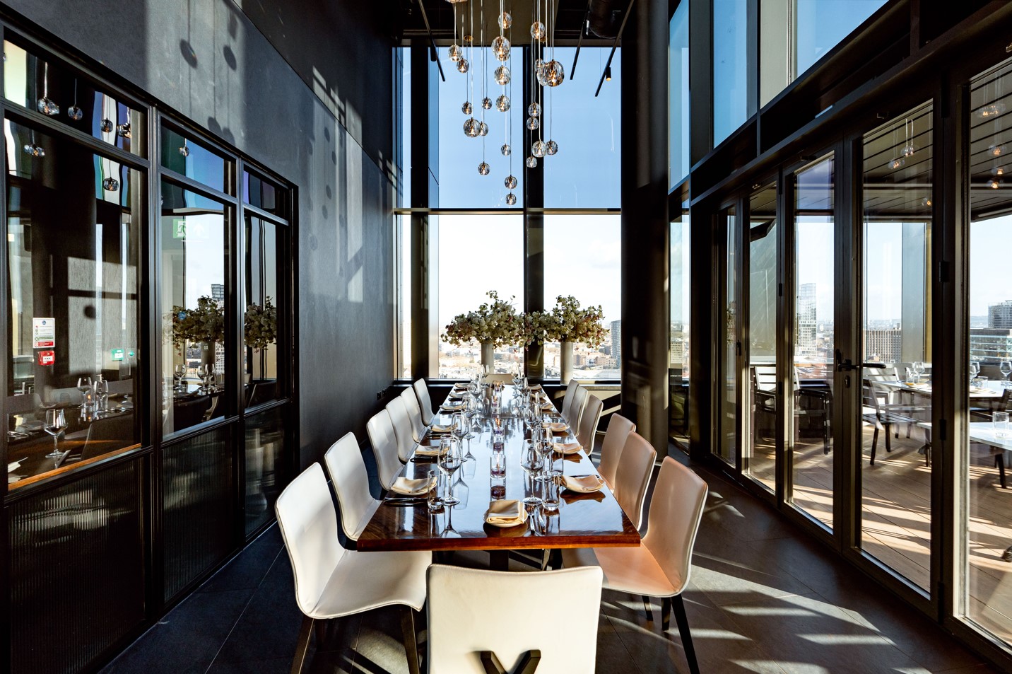 Private dining room at STK Rooftop Stratford, modern decor for upscale events and meetings.