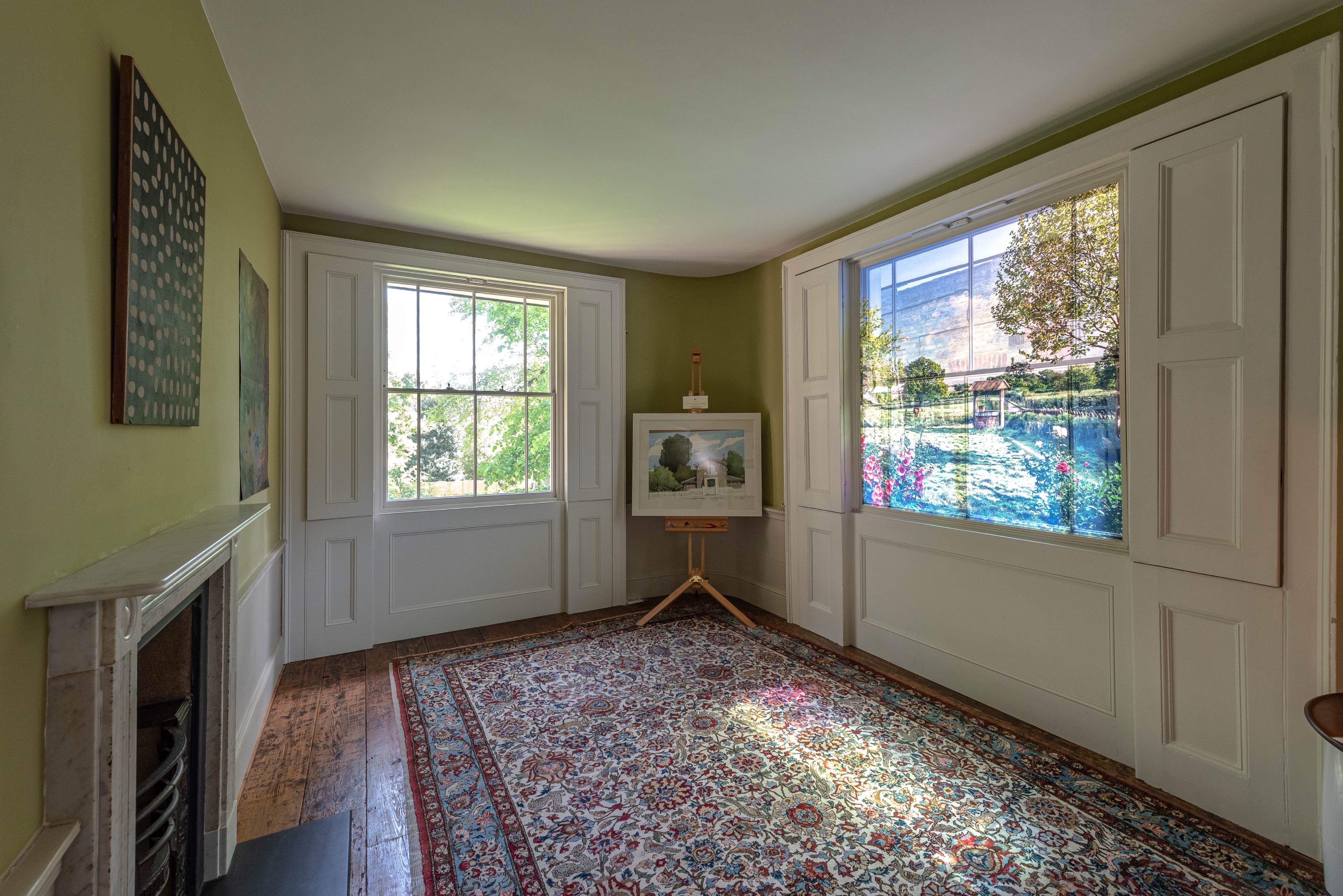 Elegant meeting space in Turner's House with large windows, perfect for gatherings and workshops.