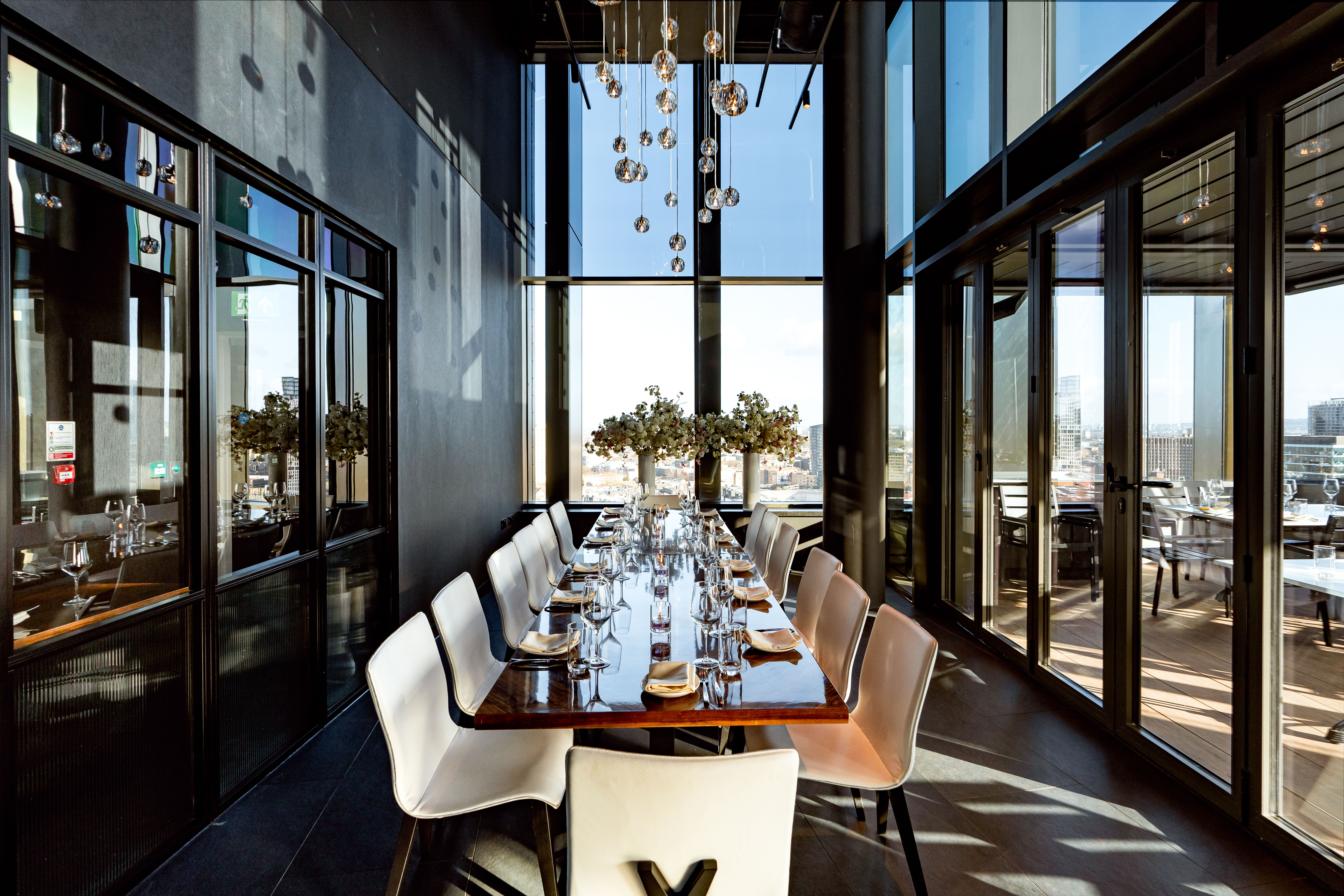 Private dining room with elegant table and views at STK Rooftop Stratford for upscale events.