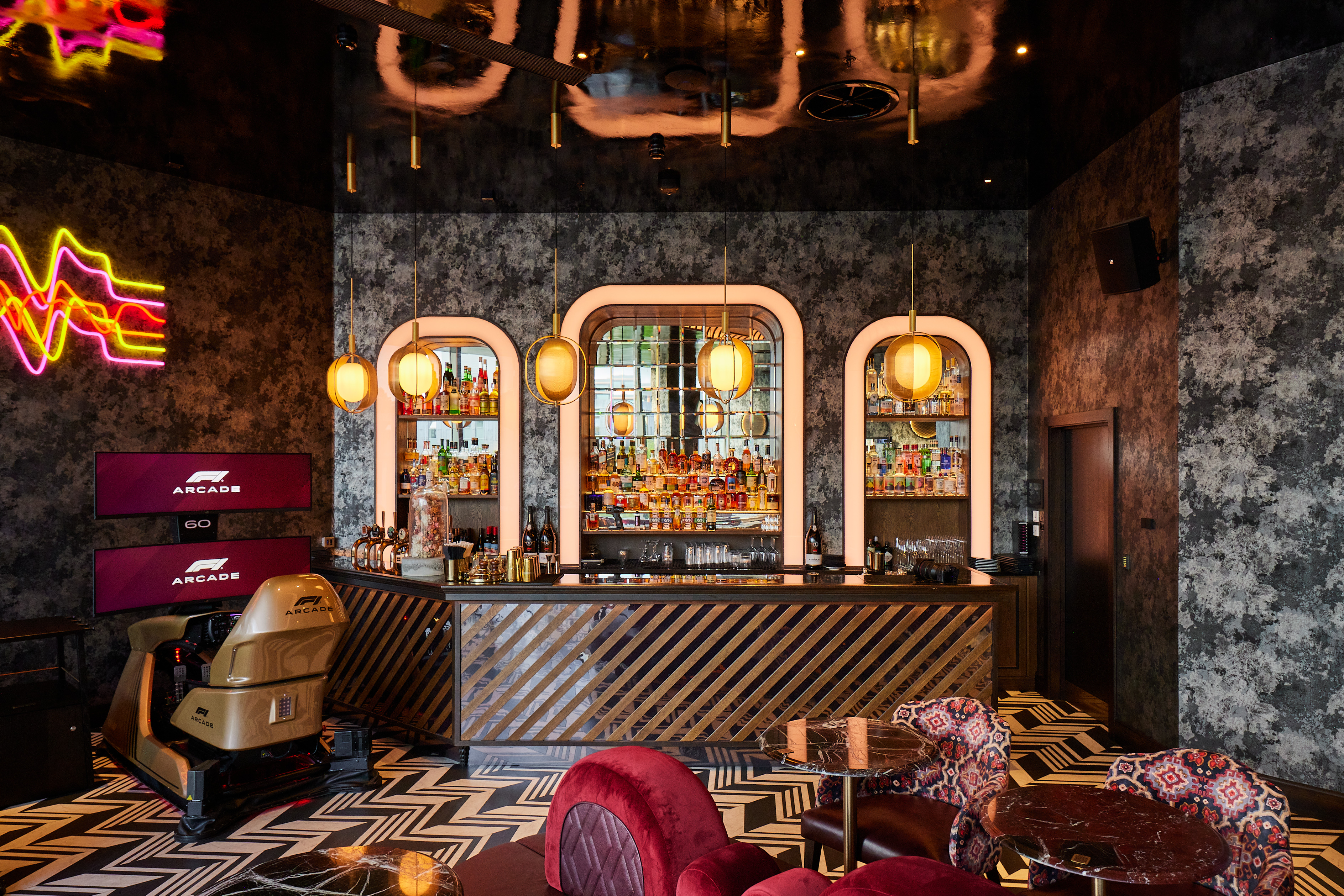 Stylish F1 Arcade Briefing Room bar with neon accents for networking events and receptions.