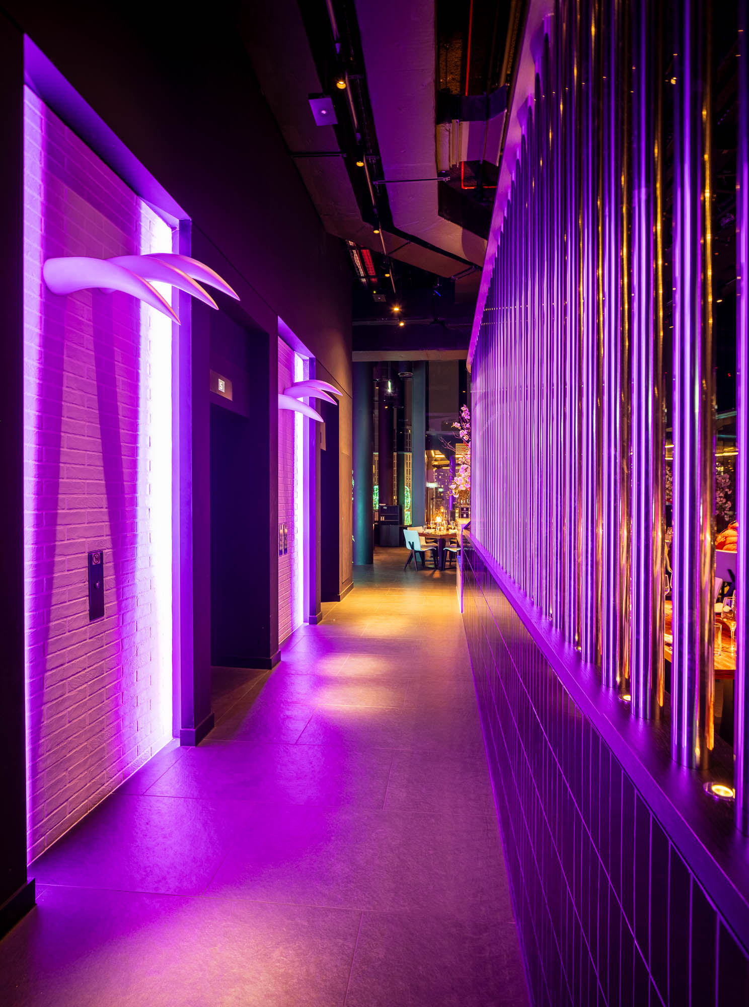 Stylish STK Rooftop corridor with purple lighting for upscale events and gatherings.
