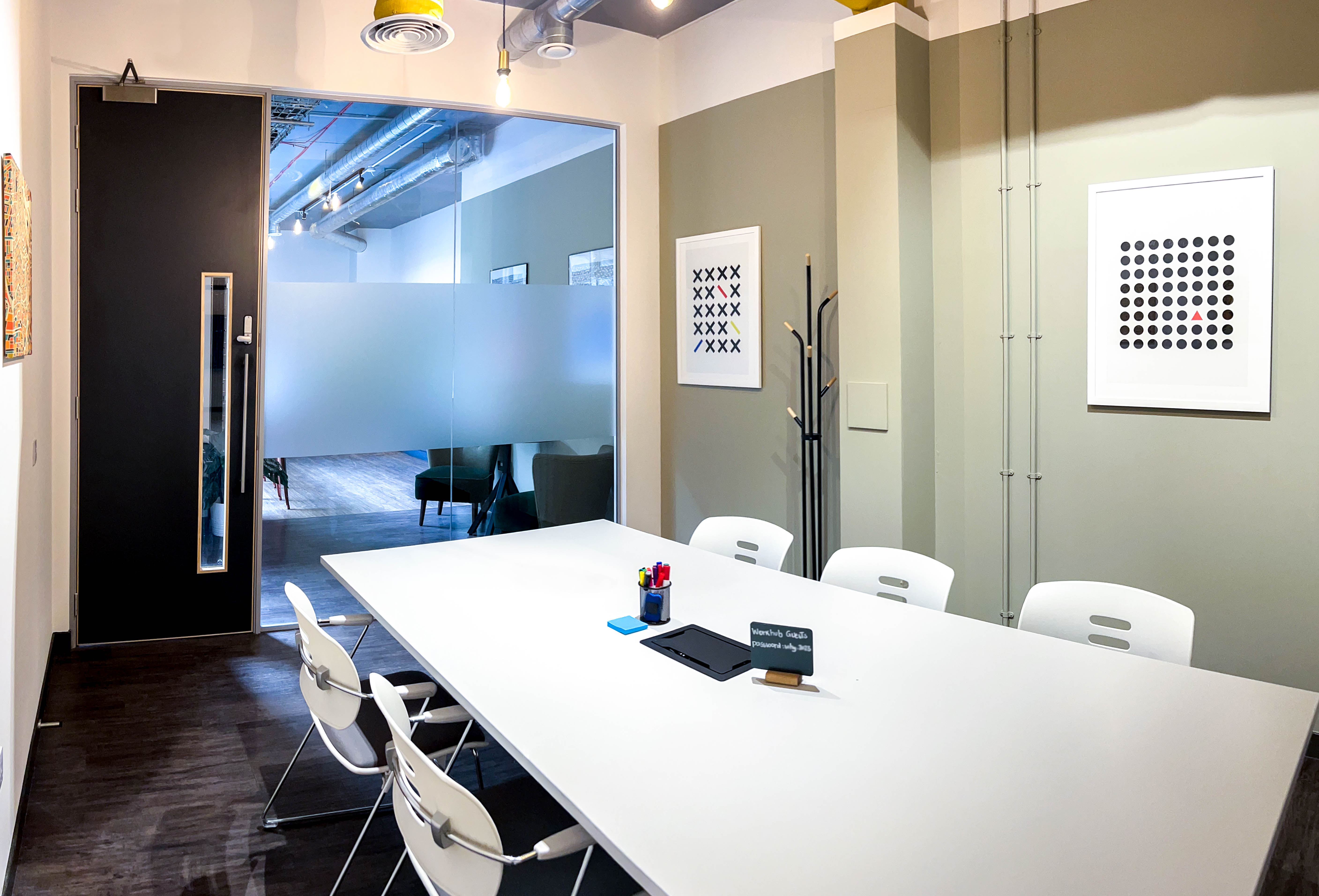 Modern meeting room with spacious table, ideal for brainstorming and client meetings.