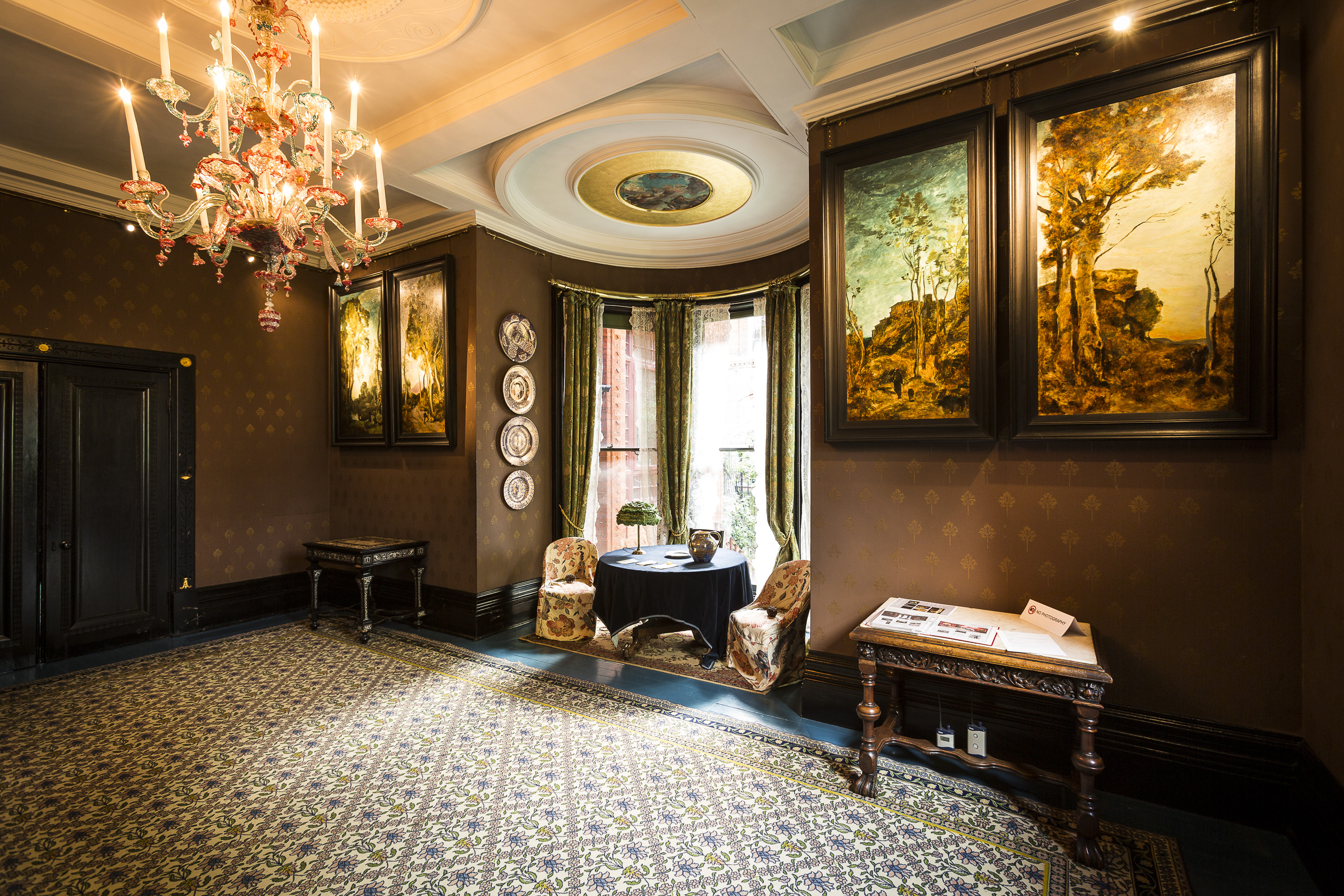 Elegant meeting space in Leighton House with dark walls, ideal for upscale events.