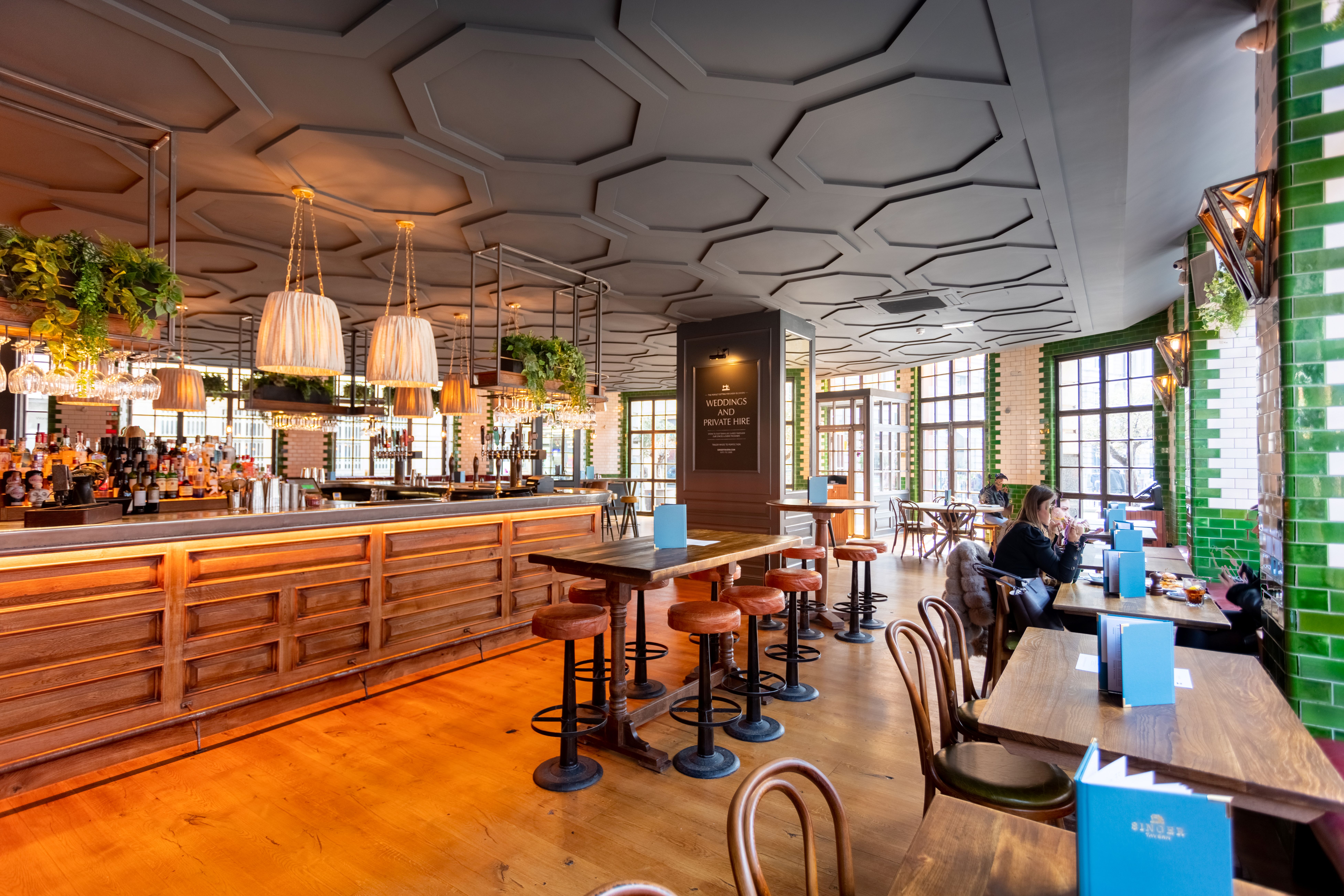 Main Bar at Singer Tavern: modern venue with warm wood tones, ideal for networking events.