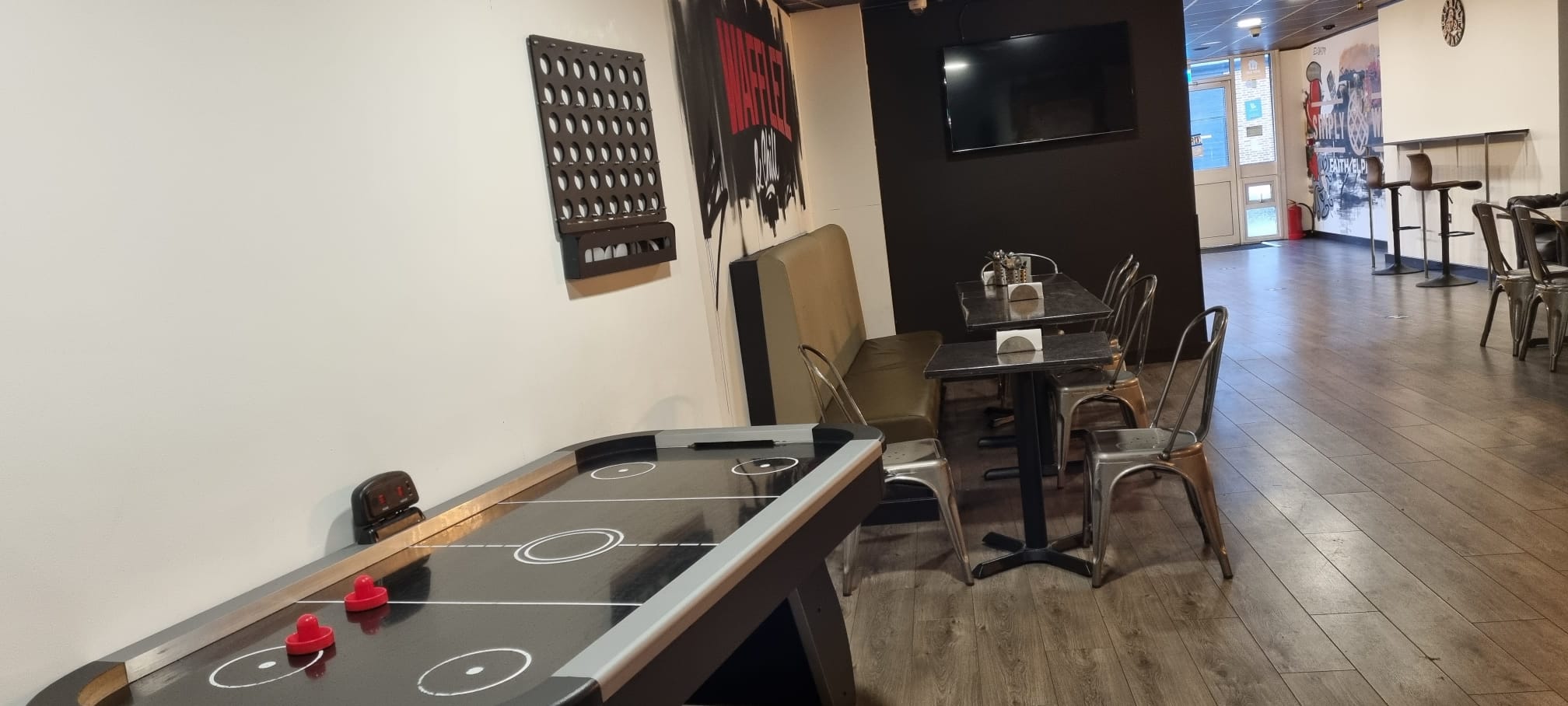 Casual meeting space with air hockey table for team-building and brainstorming activities.