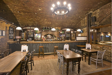 Rustic bar venue with exposed brick walls, ideal for casual gatherings and networking events.