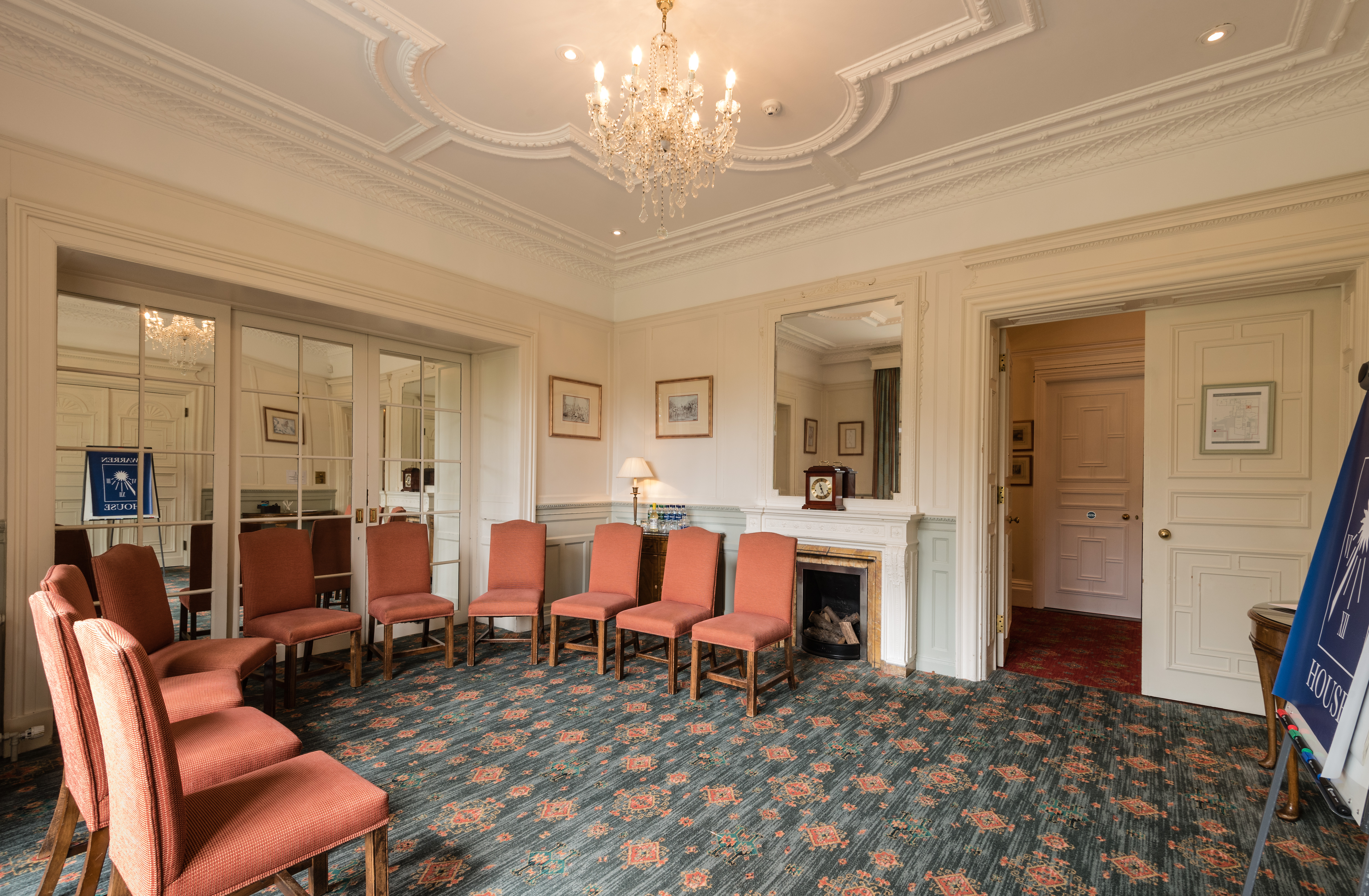 Elegant meeting room at Warren House Hotel with chandelier, ideal for small events.