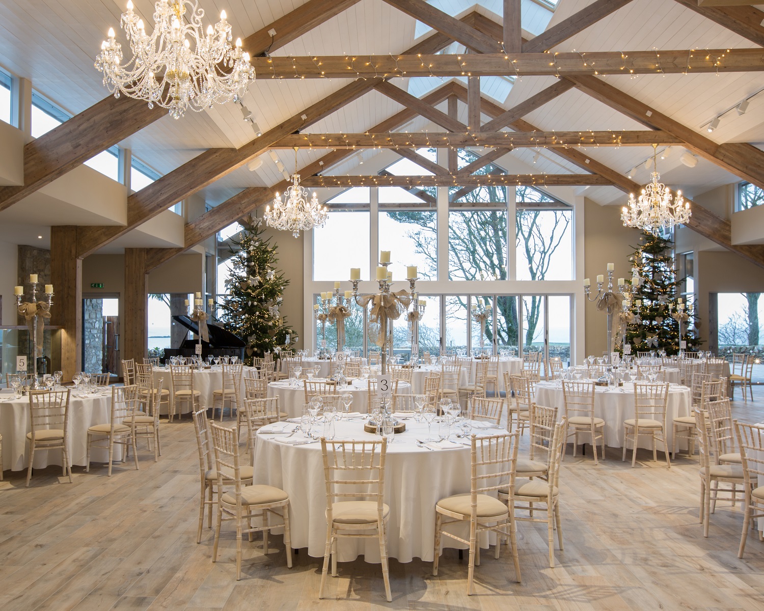 Elegant event space with round tables, ideal for weddings and formal gatherings.