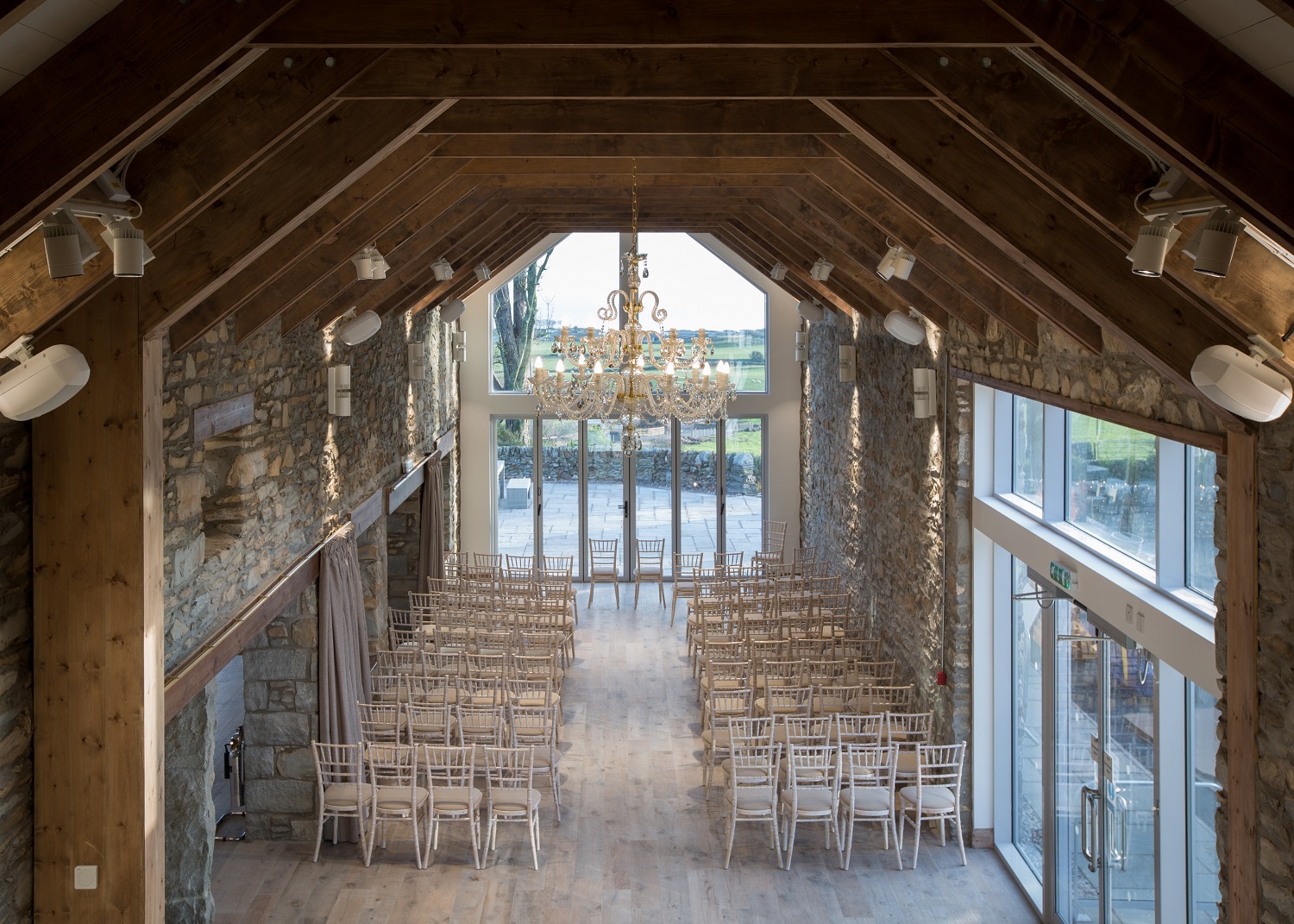 Elegant event space with wooden ceilings, perfect for weddings and gatherings.