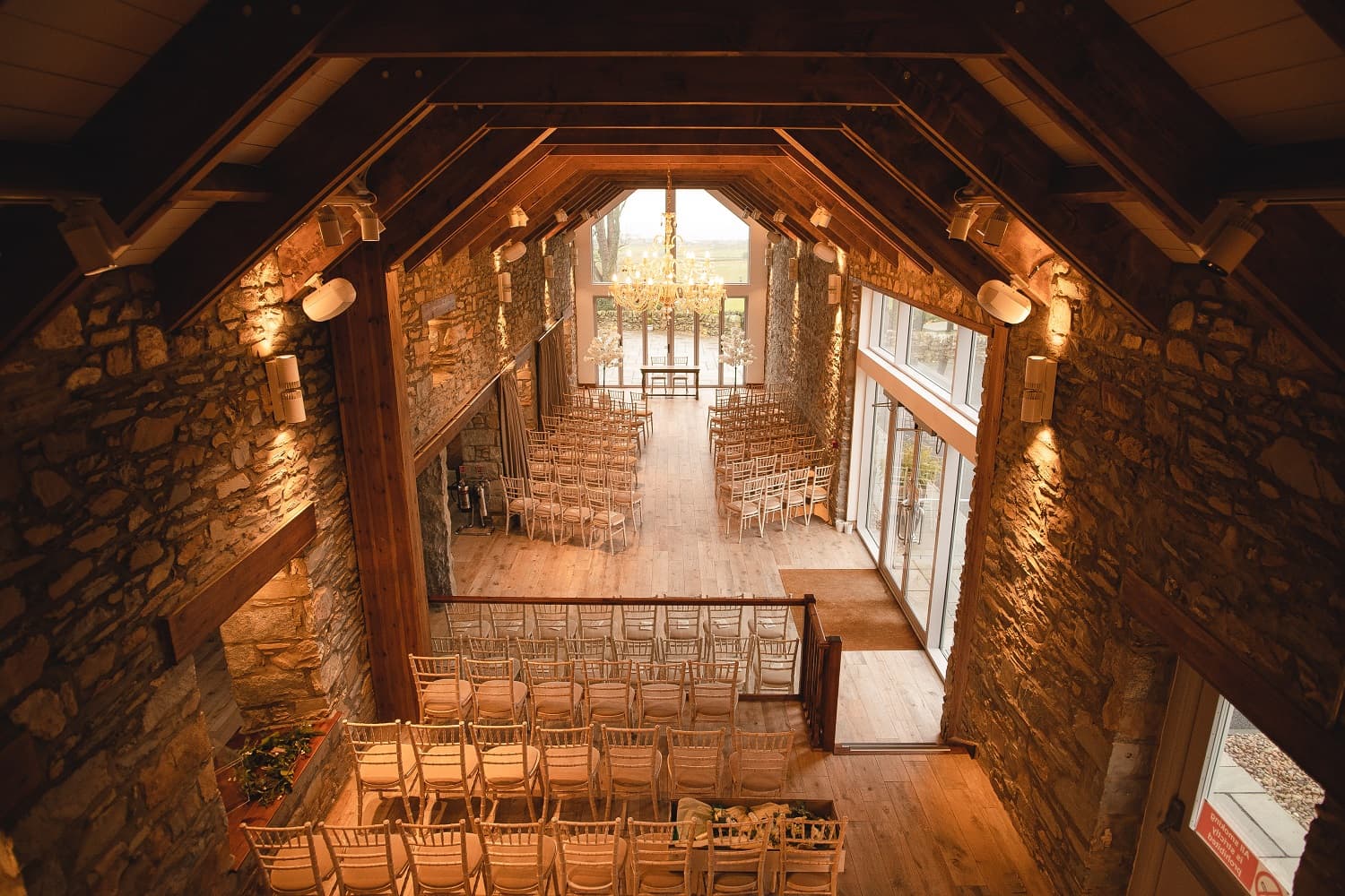 Rustic stone event space with high ceilings, perfect for weddings and corporate events.