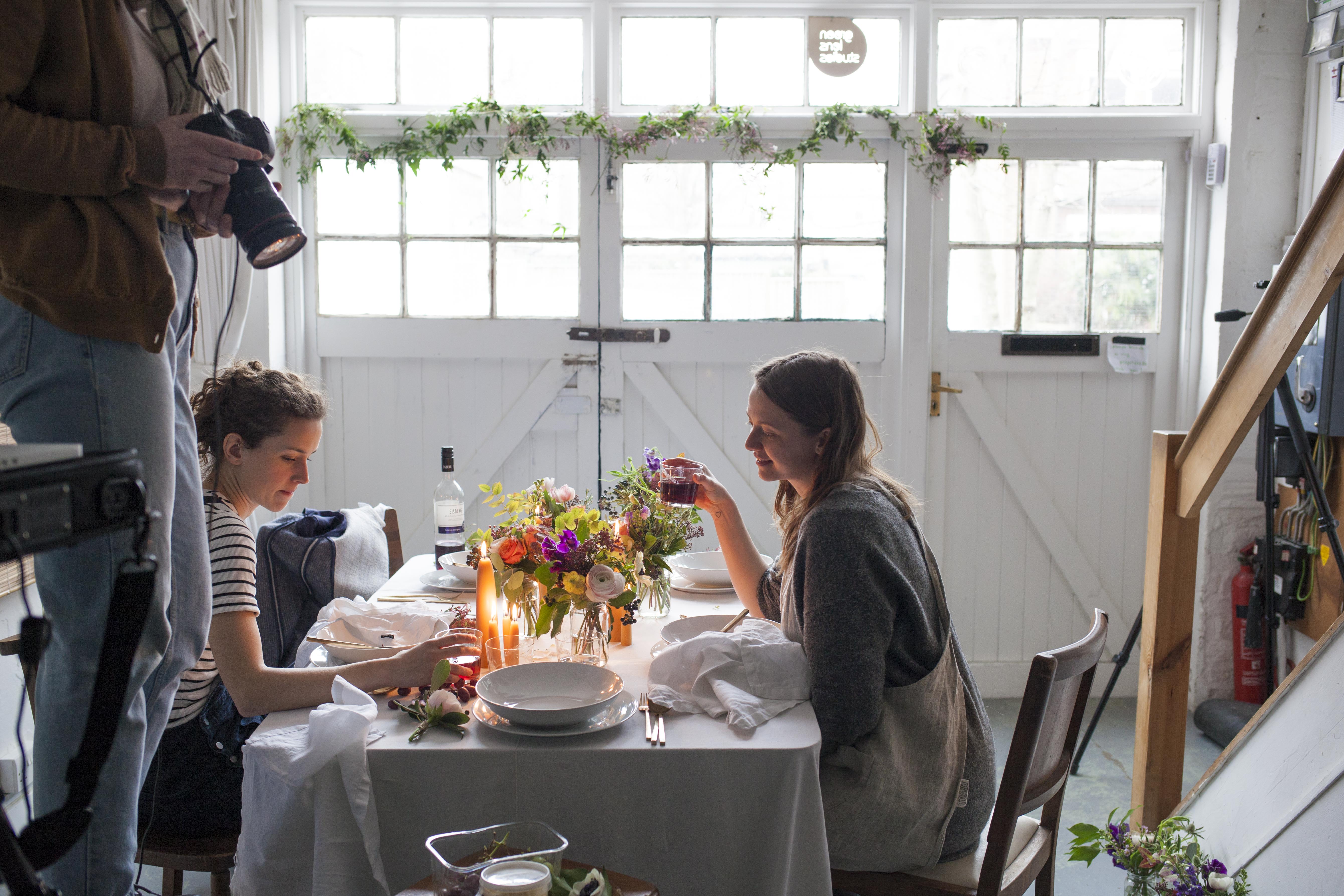 Intimate dining setup with floral centerpiece at North London Green Photographic Studio.
