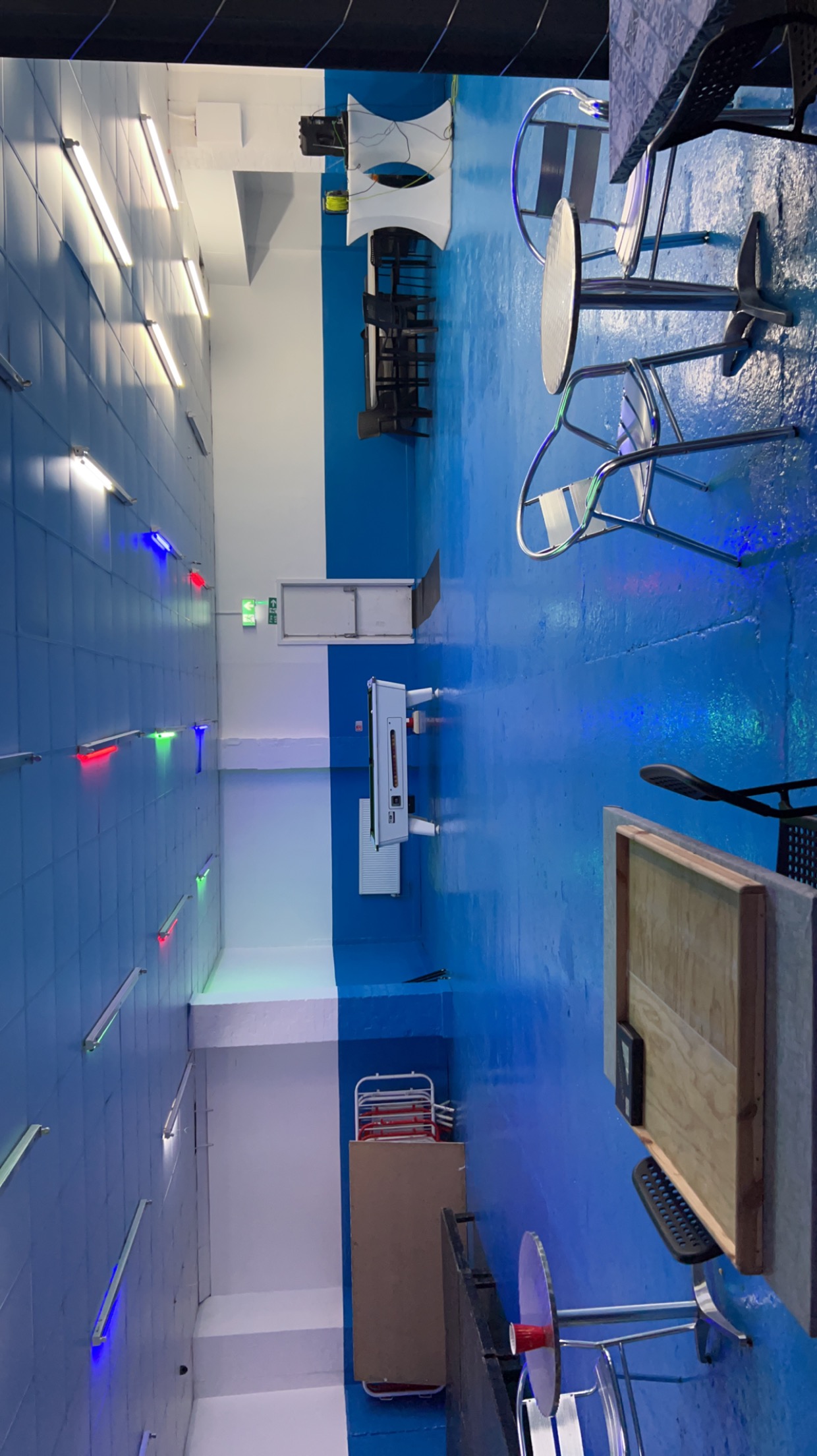 Blue Tick Bar And Grill event space with vibrant blue floor, ideal for gatherings and networking.