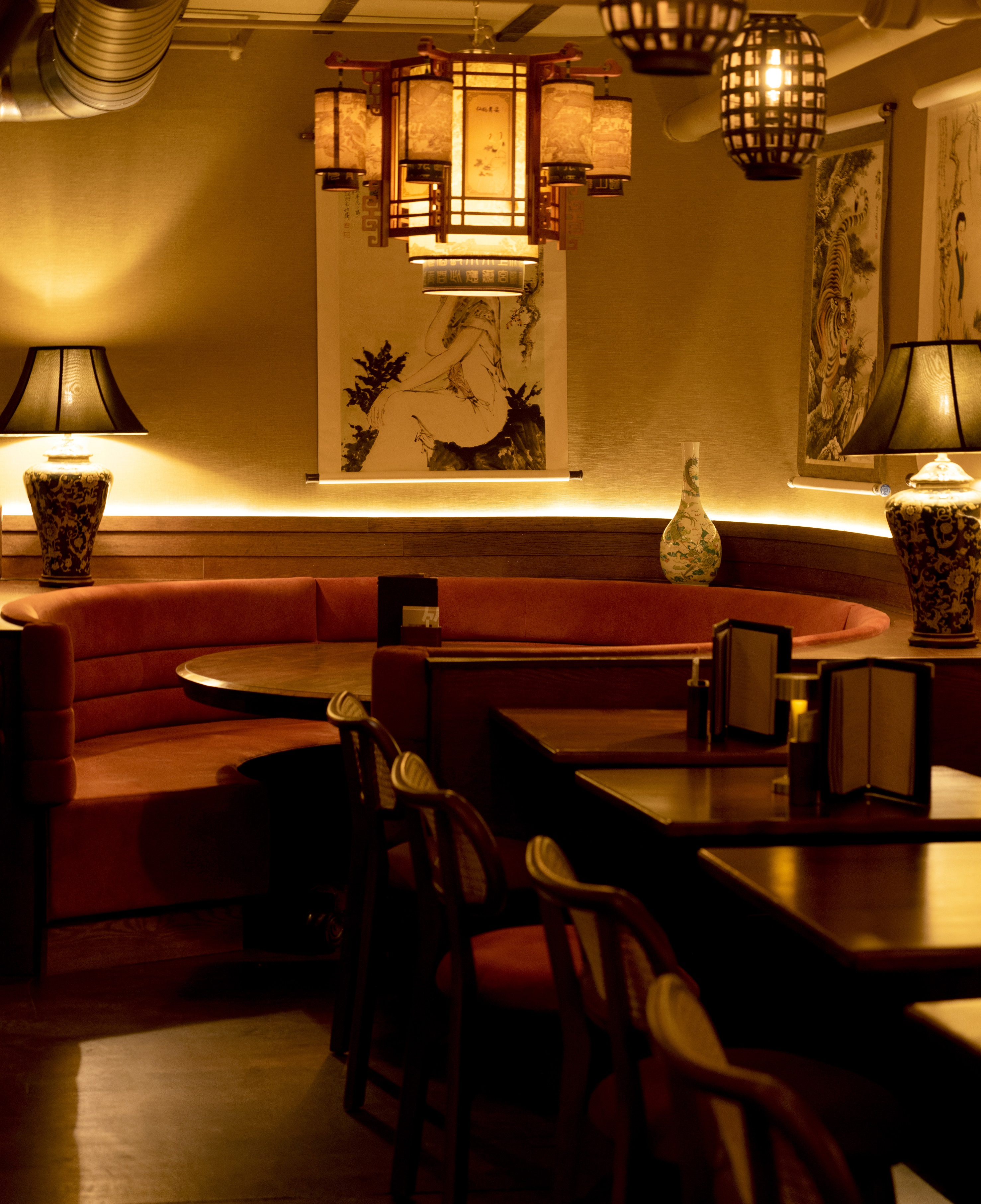Intimate dining space at Lucy Wong with plush seating, ideal for upscale events.