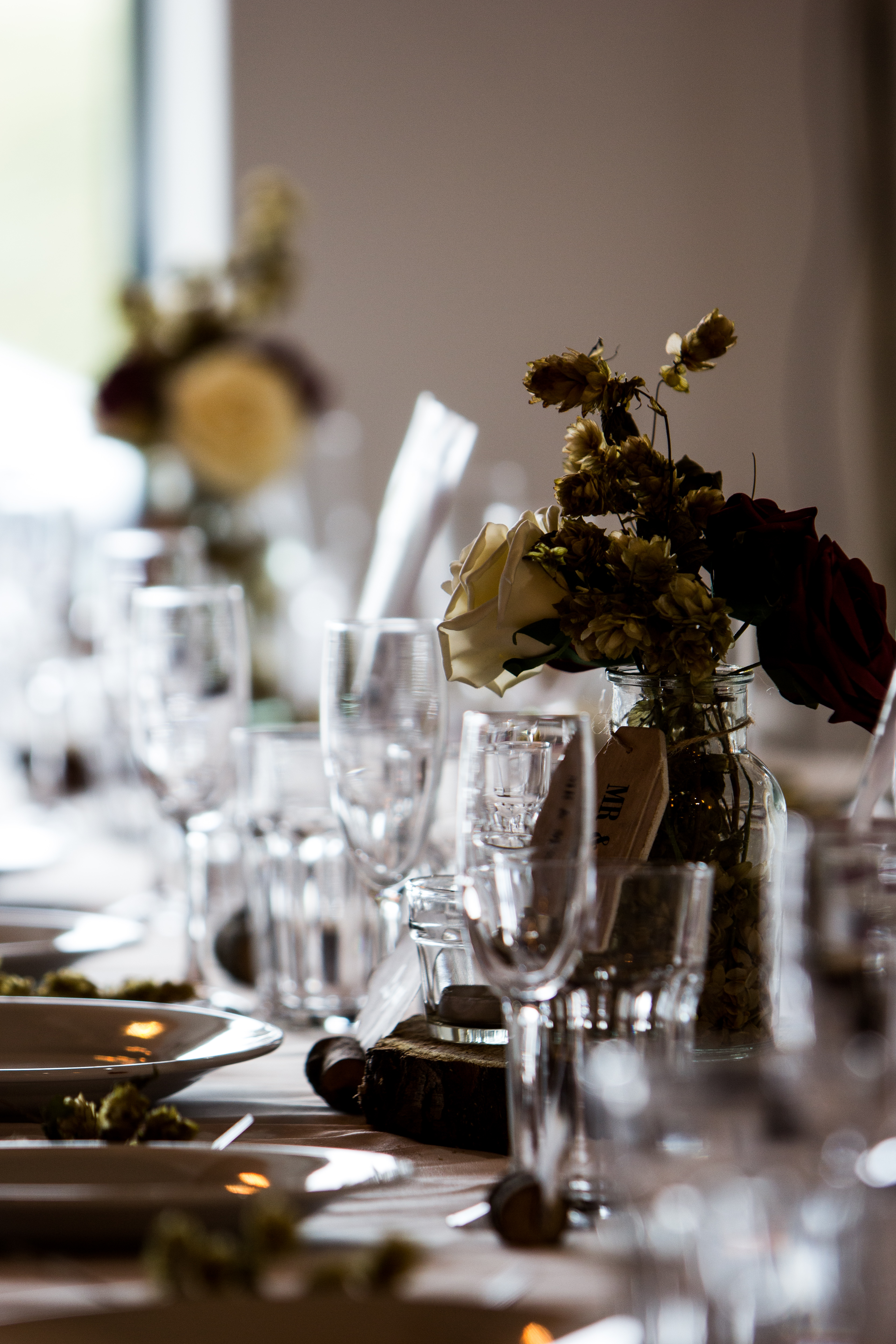 Elegant table setting with floral arrangements at Rising Cafe, Anchor Point for events.