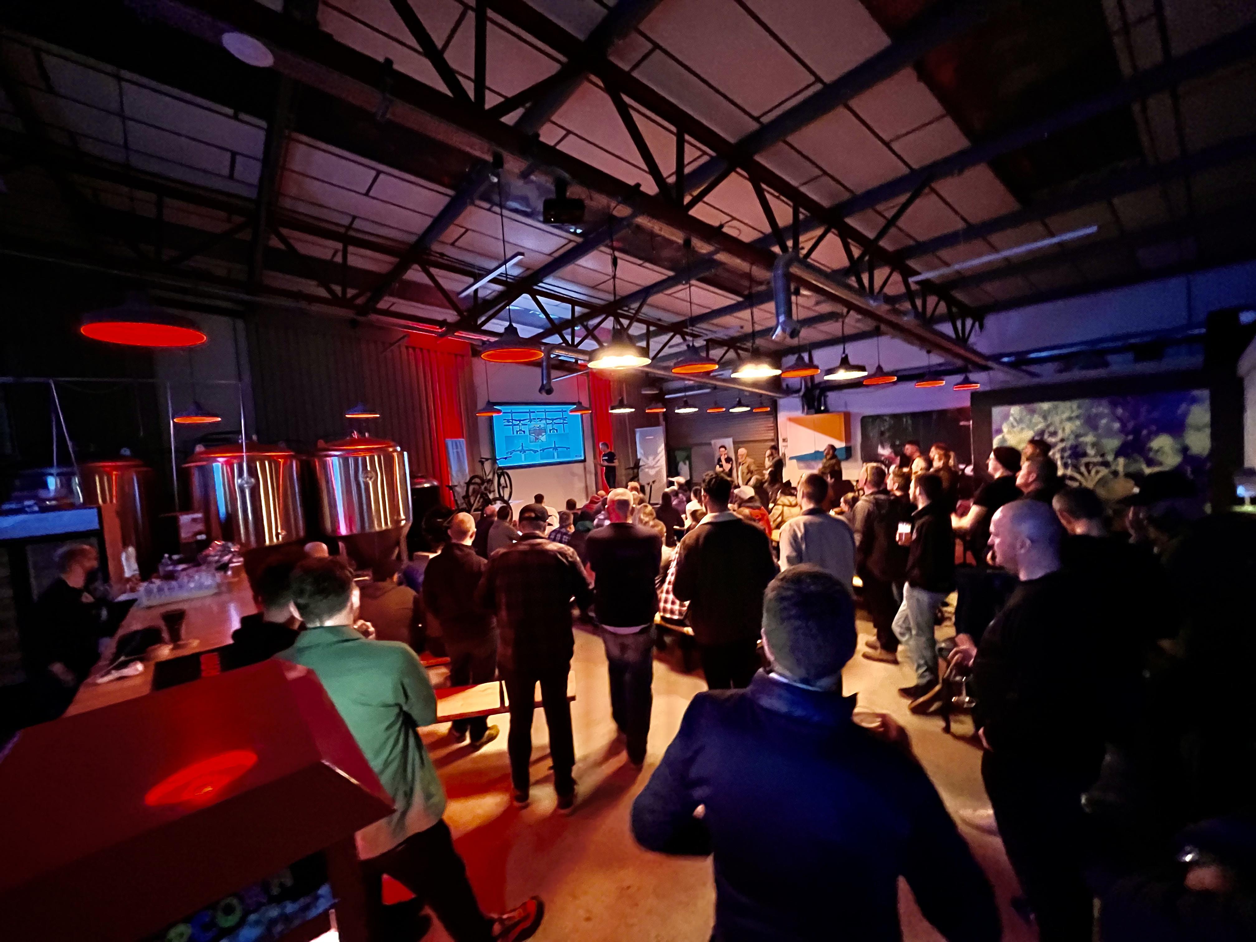 Brewery event space with attendees at a presentation in Halton Turner Brewing Co.