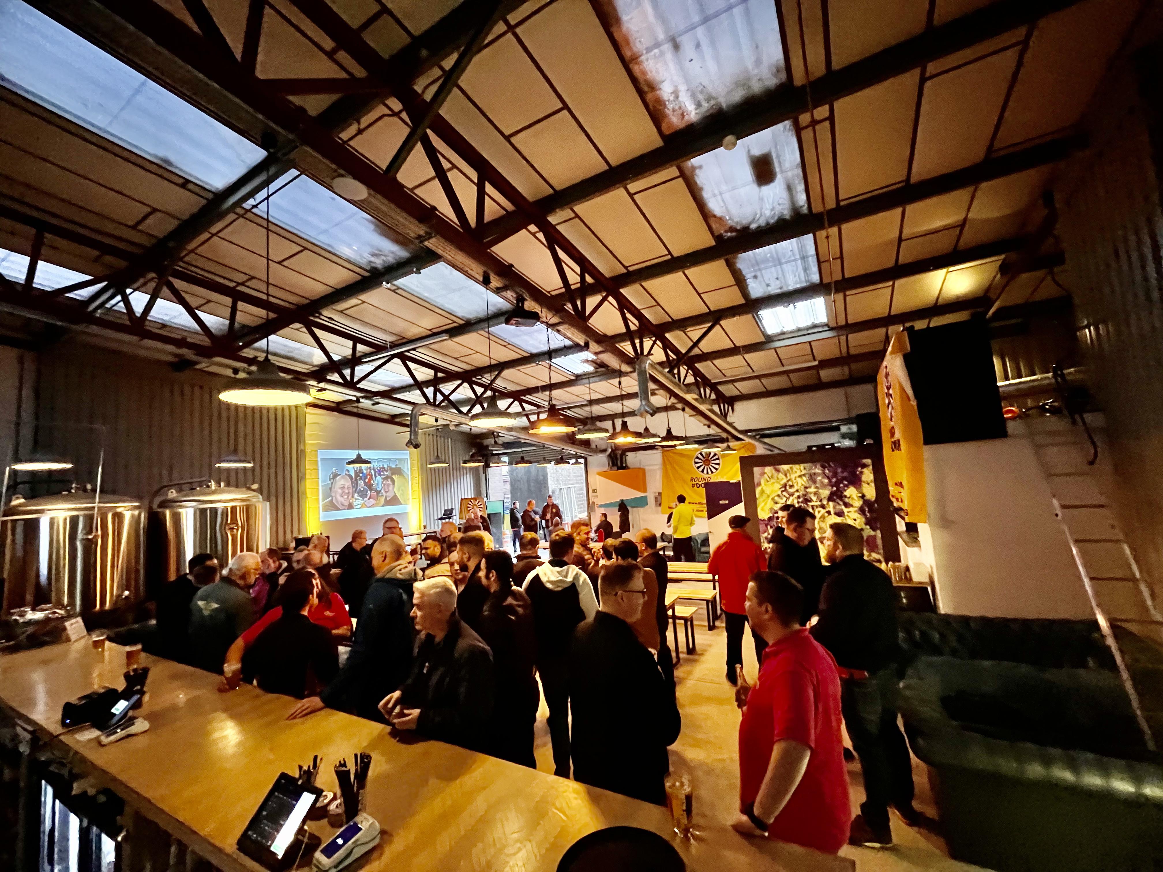 Brewery event space with industrial decor, perfect for networking and presentations.