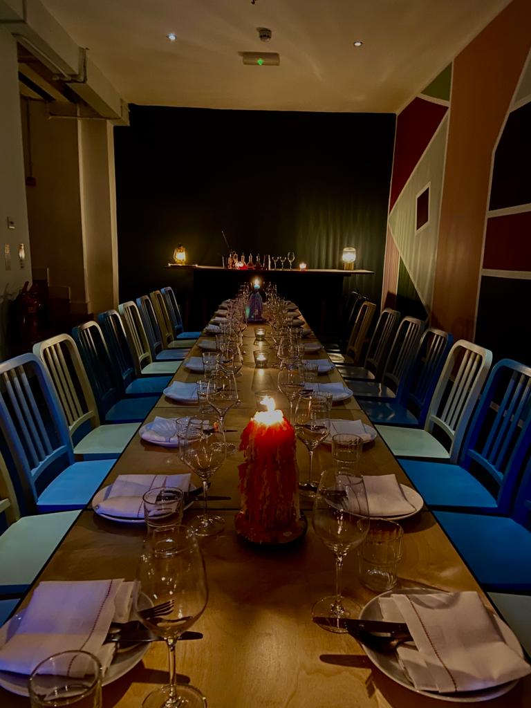 Elegant long dining table with candlelight for intimate dinners and networking events.