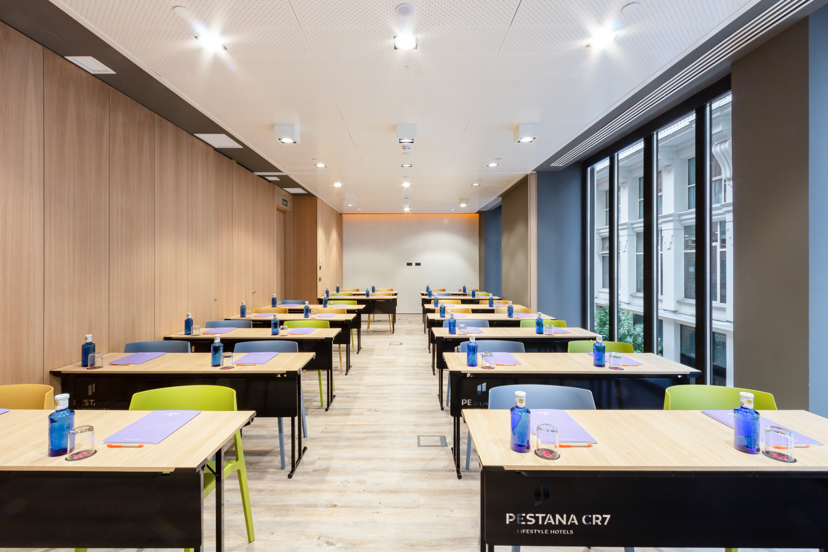 Modern meeting room with colorful chairs for a workshop at Pestana CR7 Gran Via.