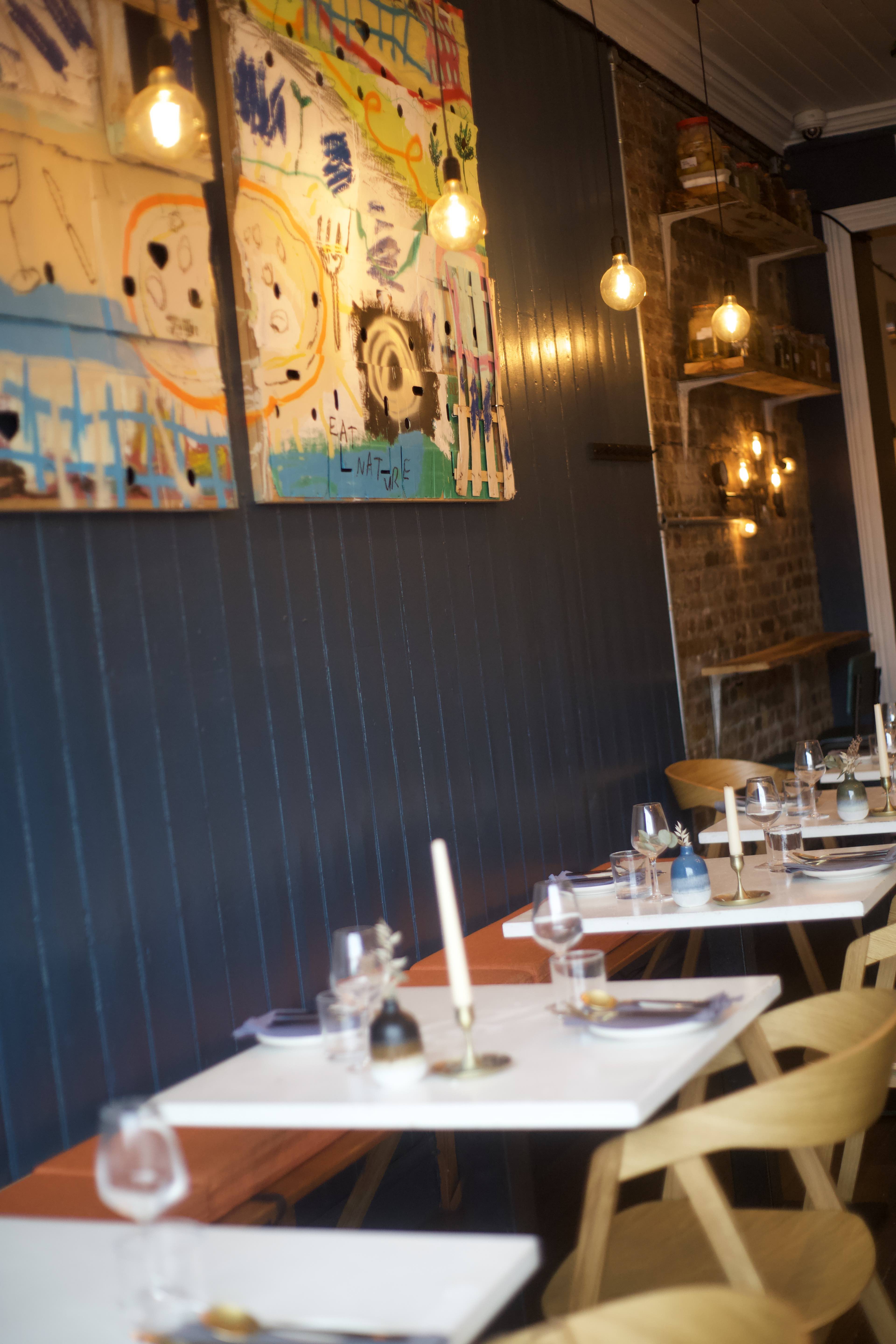 Stylish dining space with modern art, perfect for intimate gatherings and corporate events.