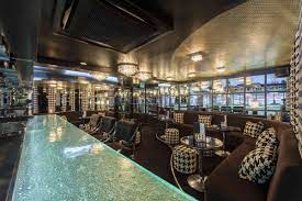 Stylish lounge at The O2, featuring a sleek bar for upscale networking events.