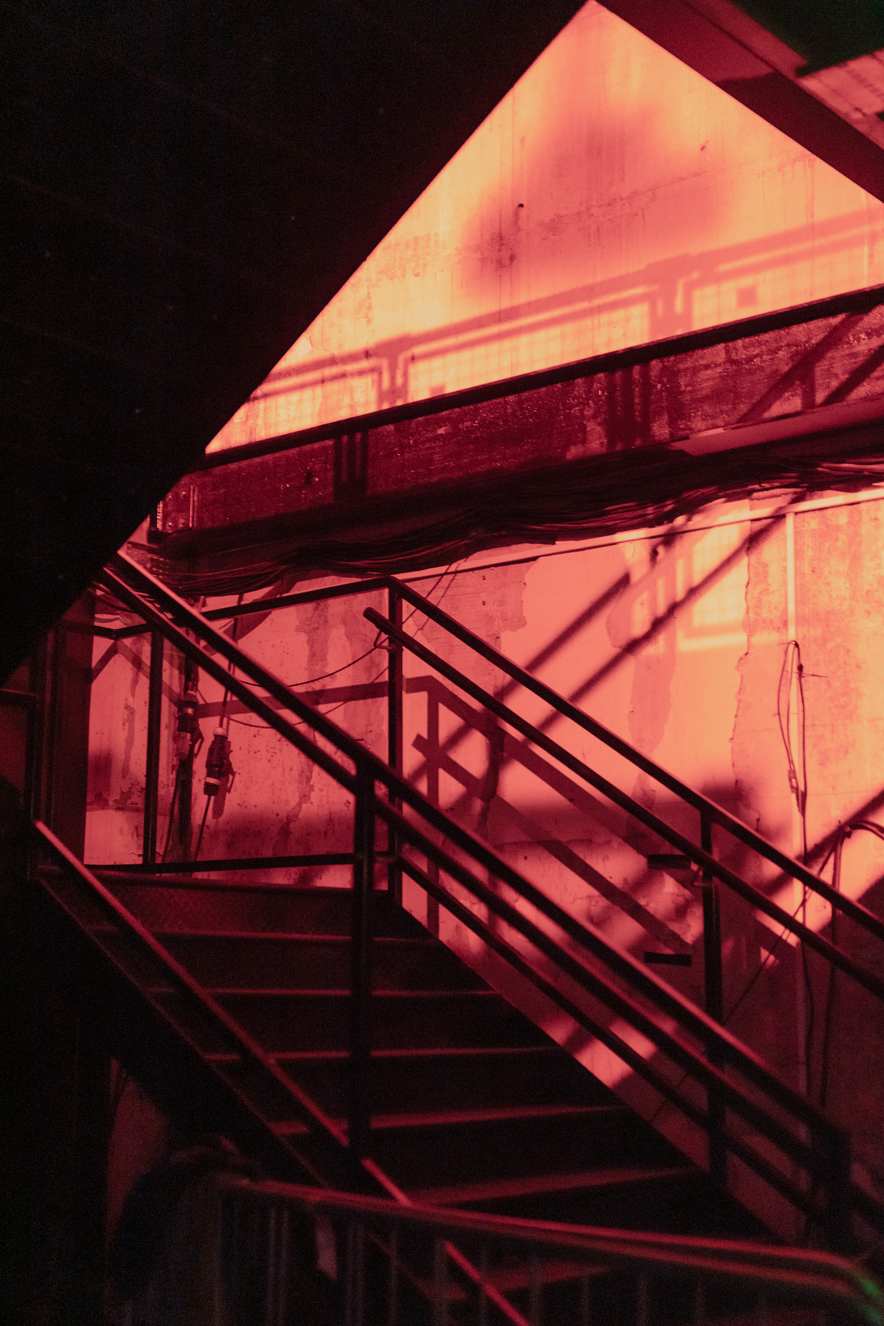 Industrial staircase with red lighting at Warehouse in The Cause for unique events.