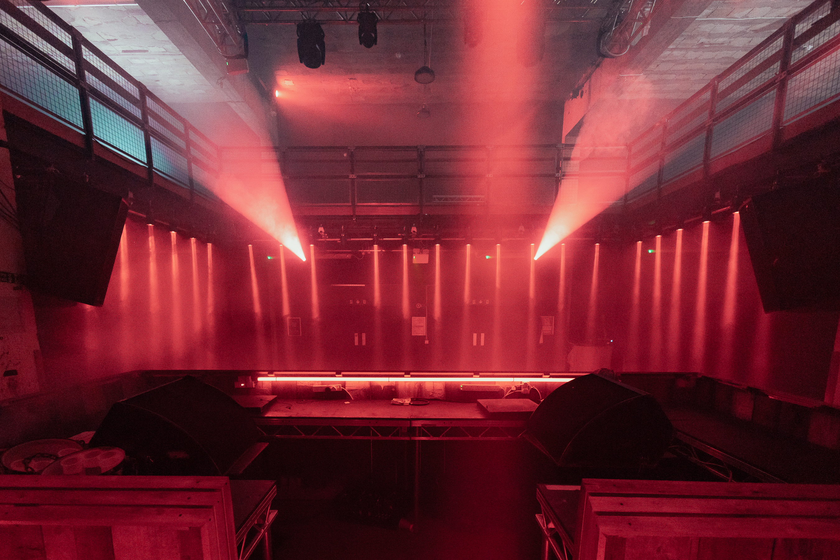 Dynamic event space at Warehouse, featuring red lighting for immersive experiences.