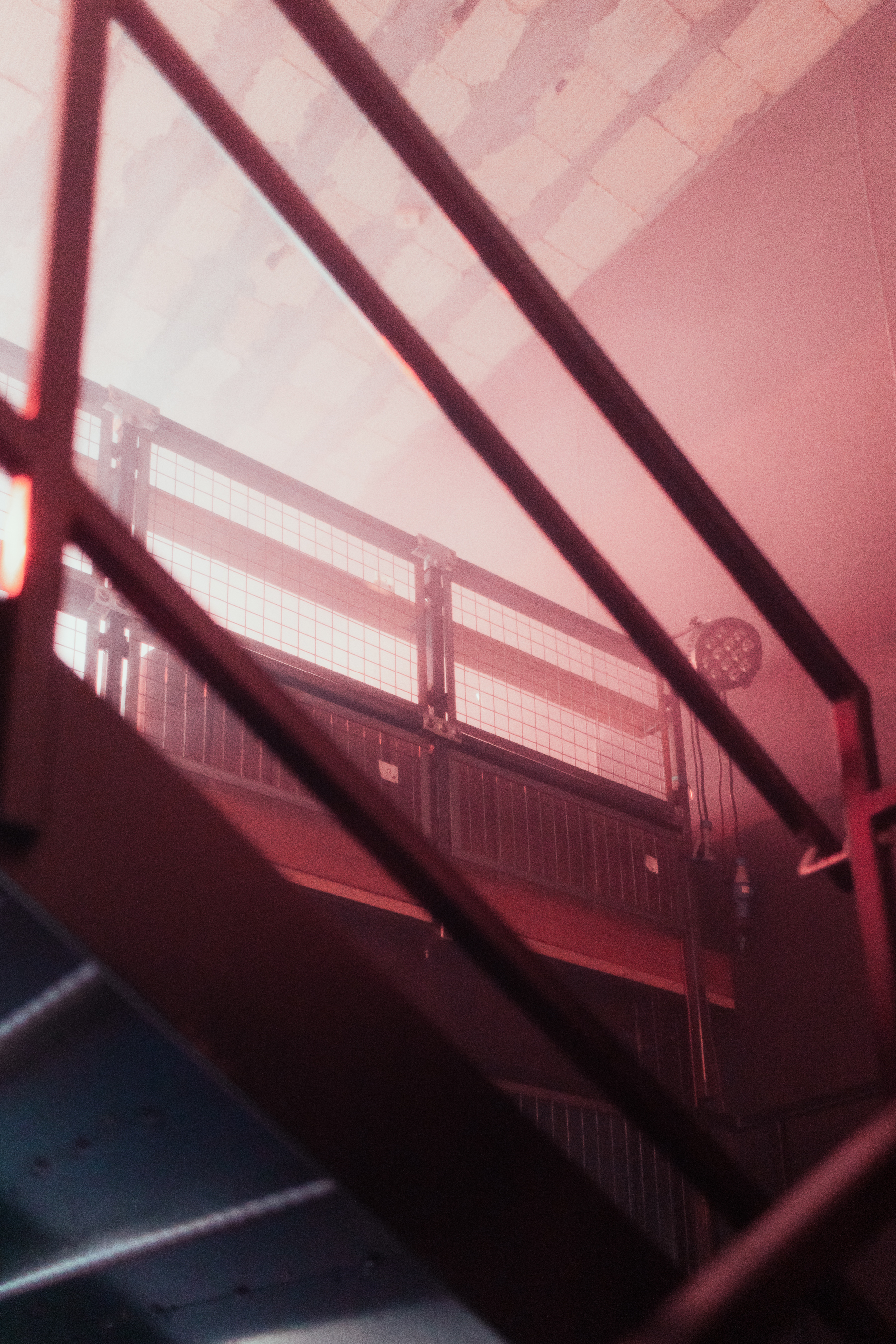 Dynamic event space at Warehouse, featuring elevated platforms and atmospheric lighting.