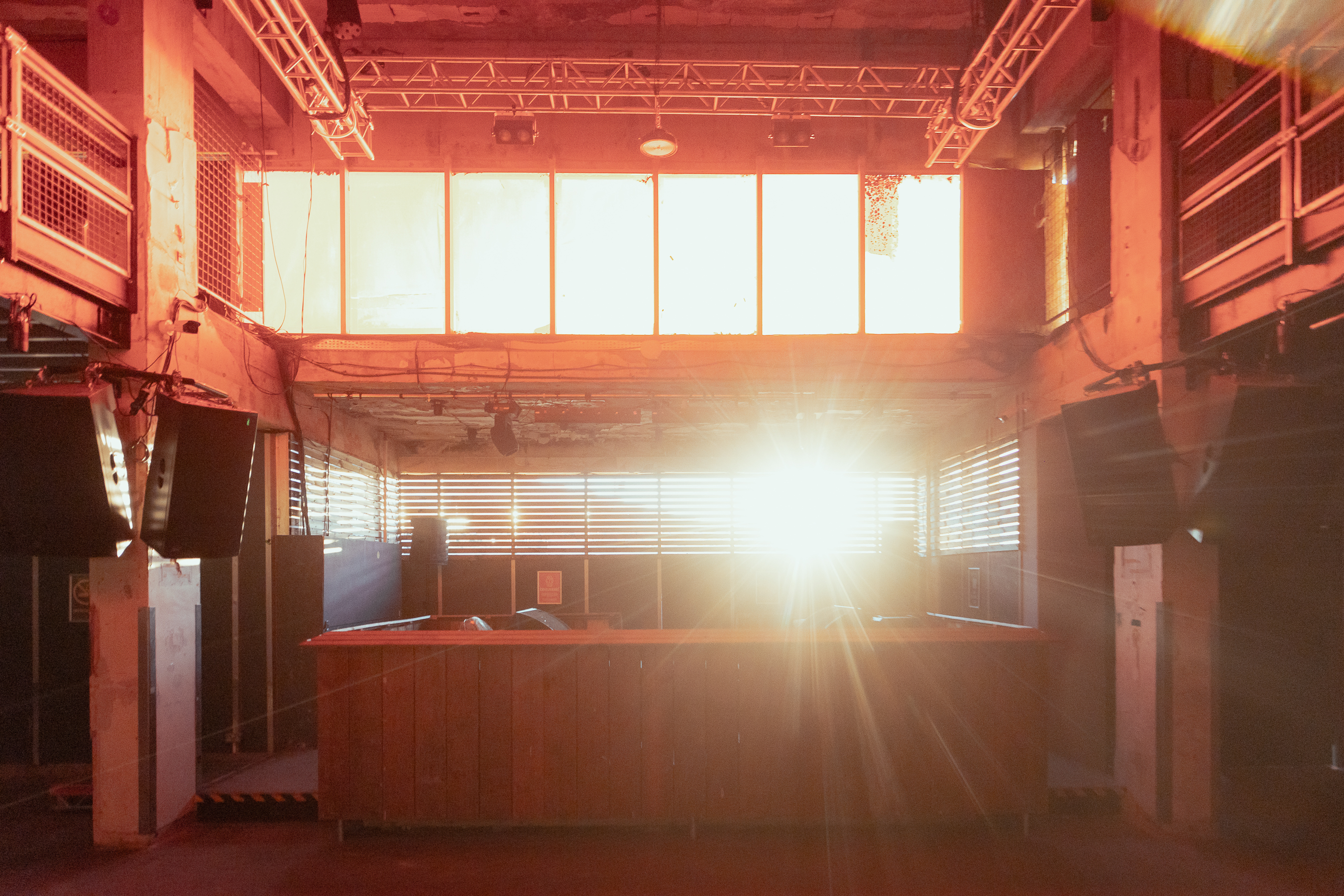 Spacious warehouse venue with large windows, ideal for events and gatherings.