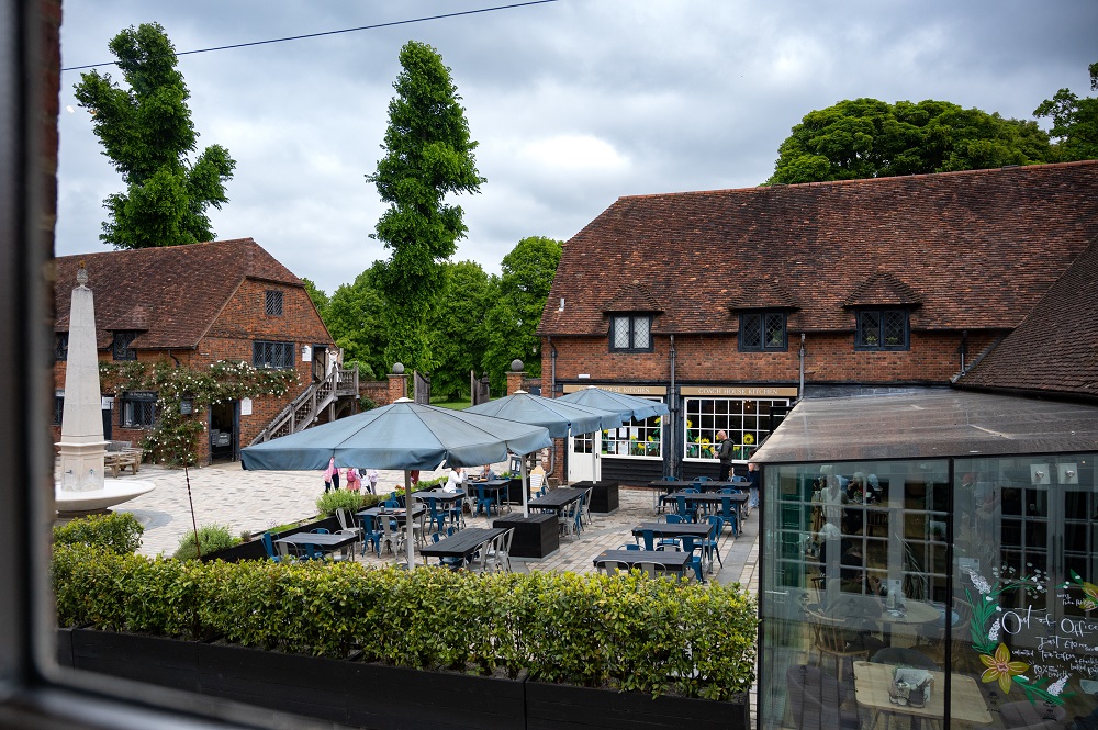 Charming outdoor venue at Coach House Kitchen, ideal for events with rustic architecture.