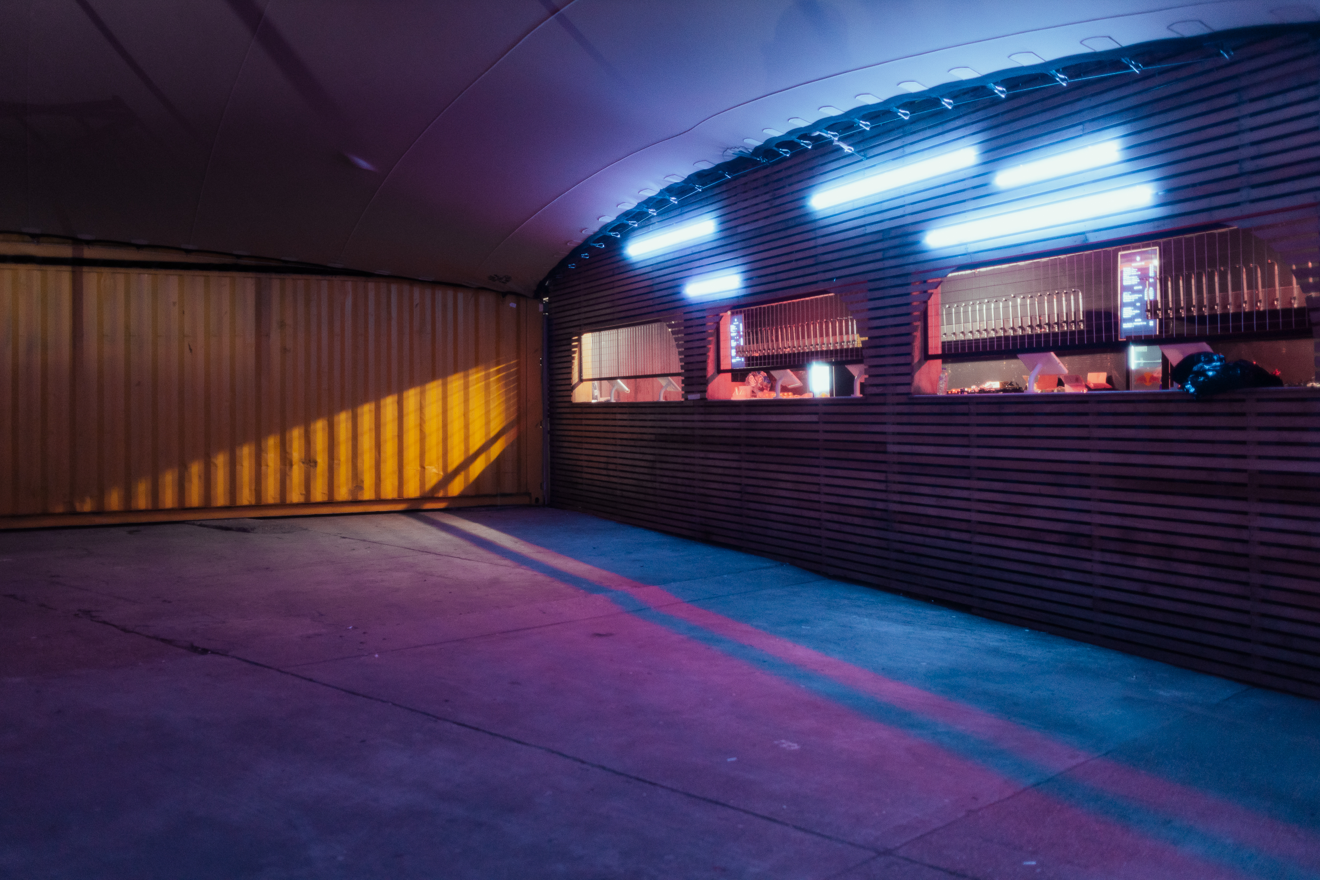 Modern industrial venue with neon lighting, perfect for events and networking.