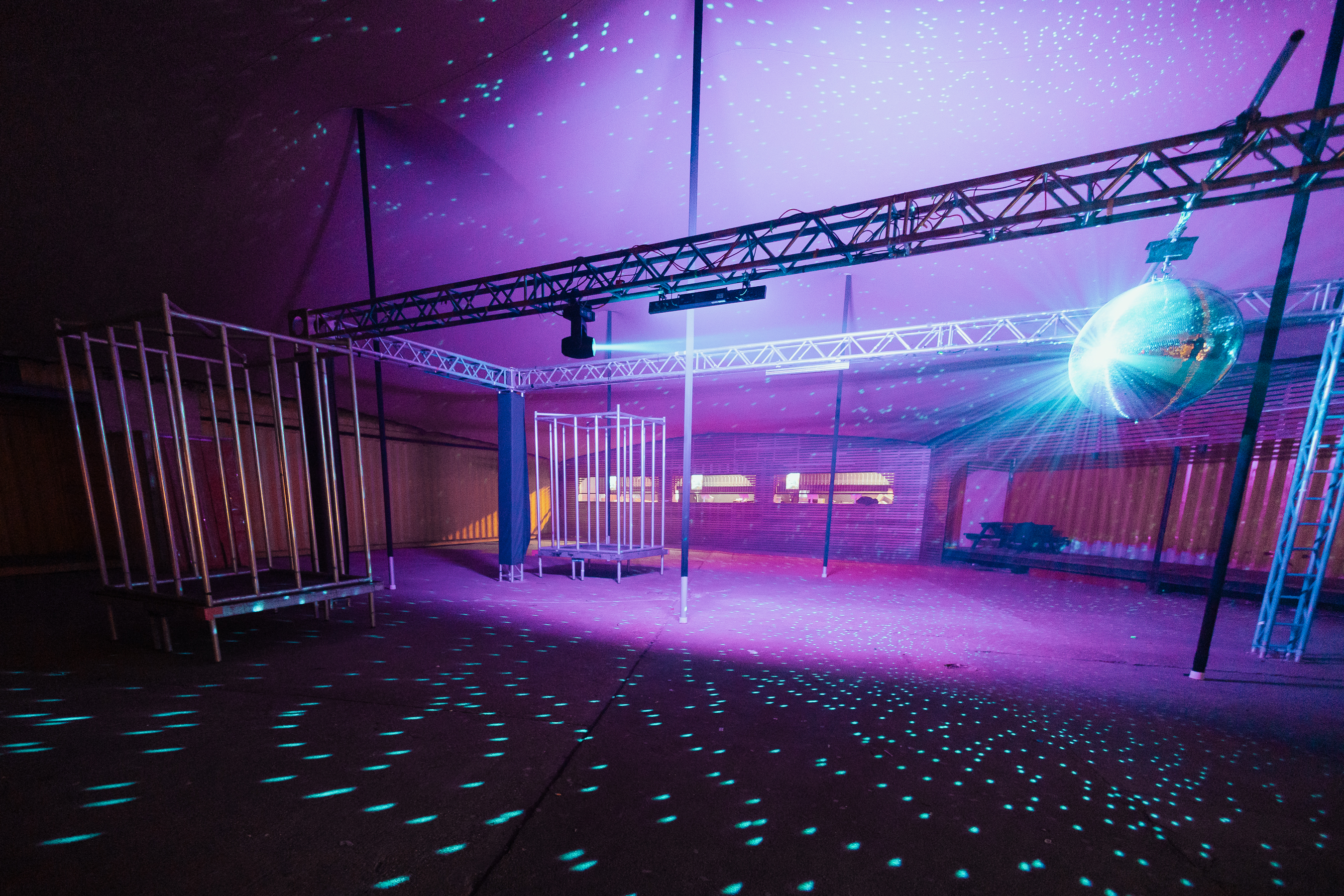 Vibrant event space with disco ball, perfect for parties and corporate gatherings.
