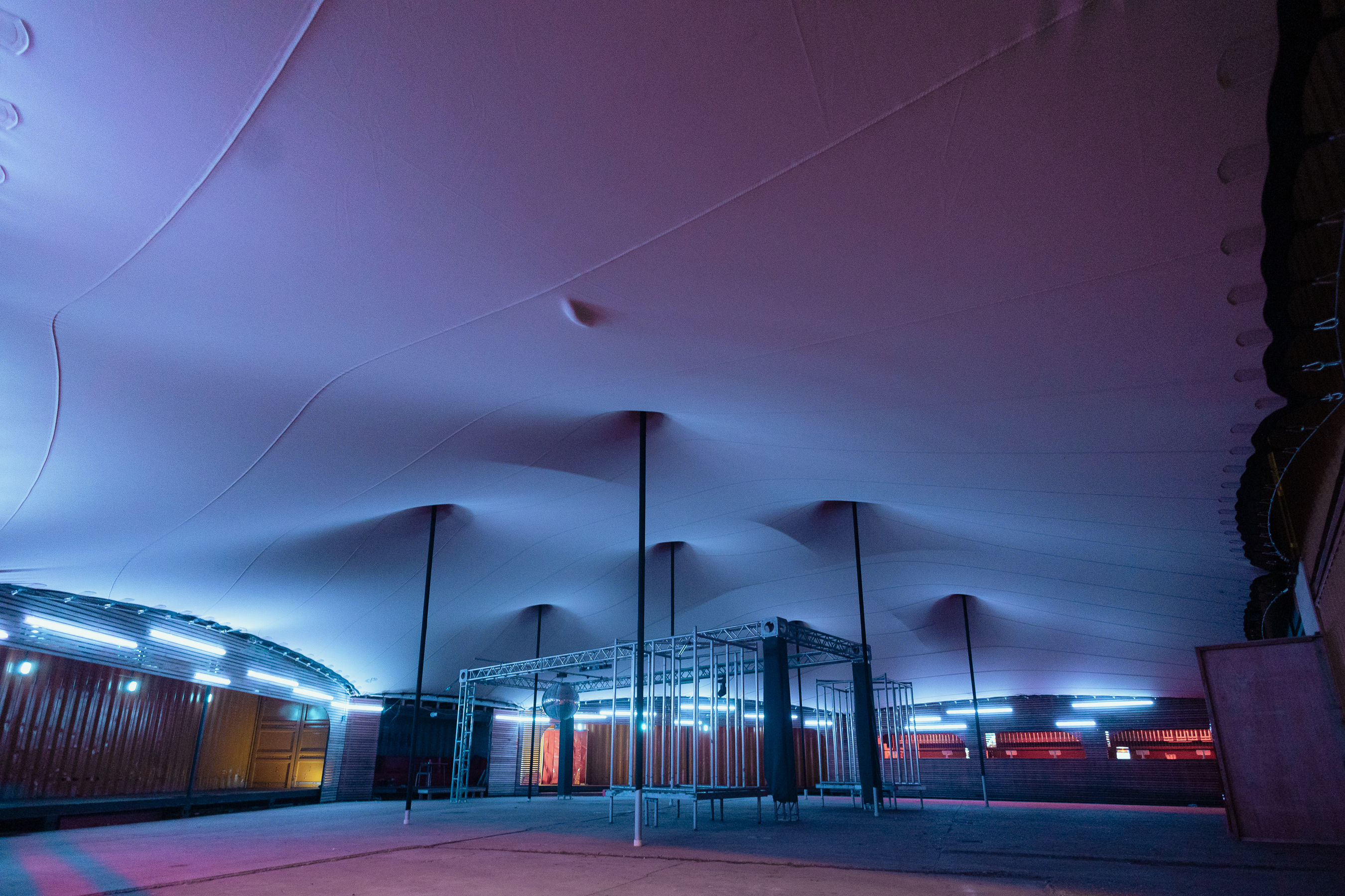 Modern event space with undulating ceiling, ideal for corporate gatherings and showcases.