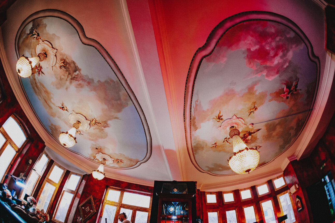Elegant frescoed ceiling at Sixty Ink, perfect for upscale events and gatherings.