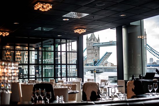 Private dining room with elegant decor and Tower Bridge view for upscale events.