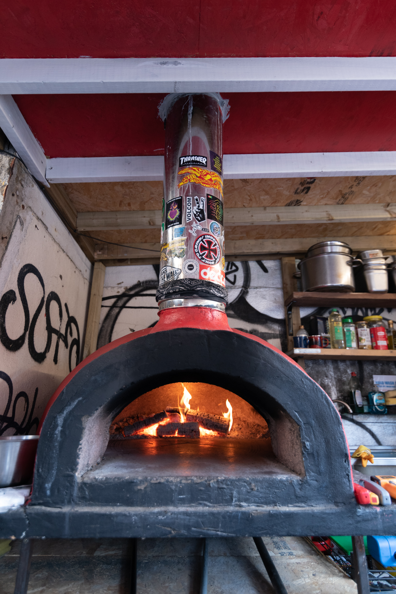 Cozy wood-burning stove in rustic setting for team-building events and gatherings.