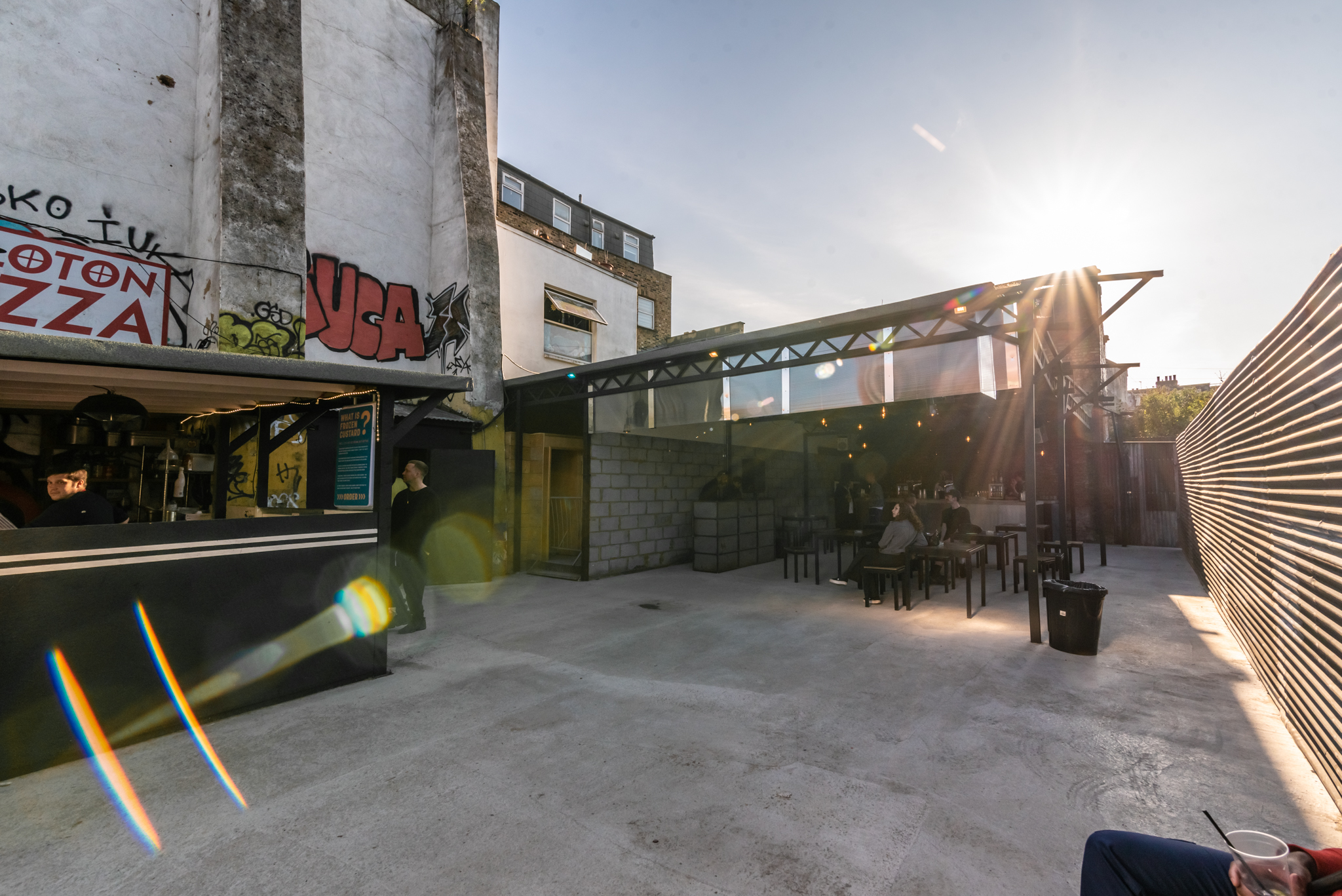 Modern outdoor event space with graffiti, perfect for casual gatherings and networking.