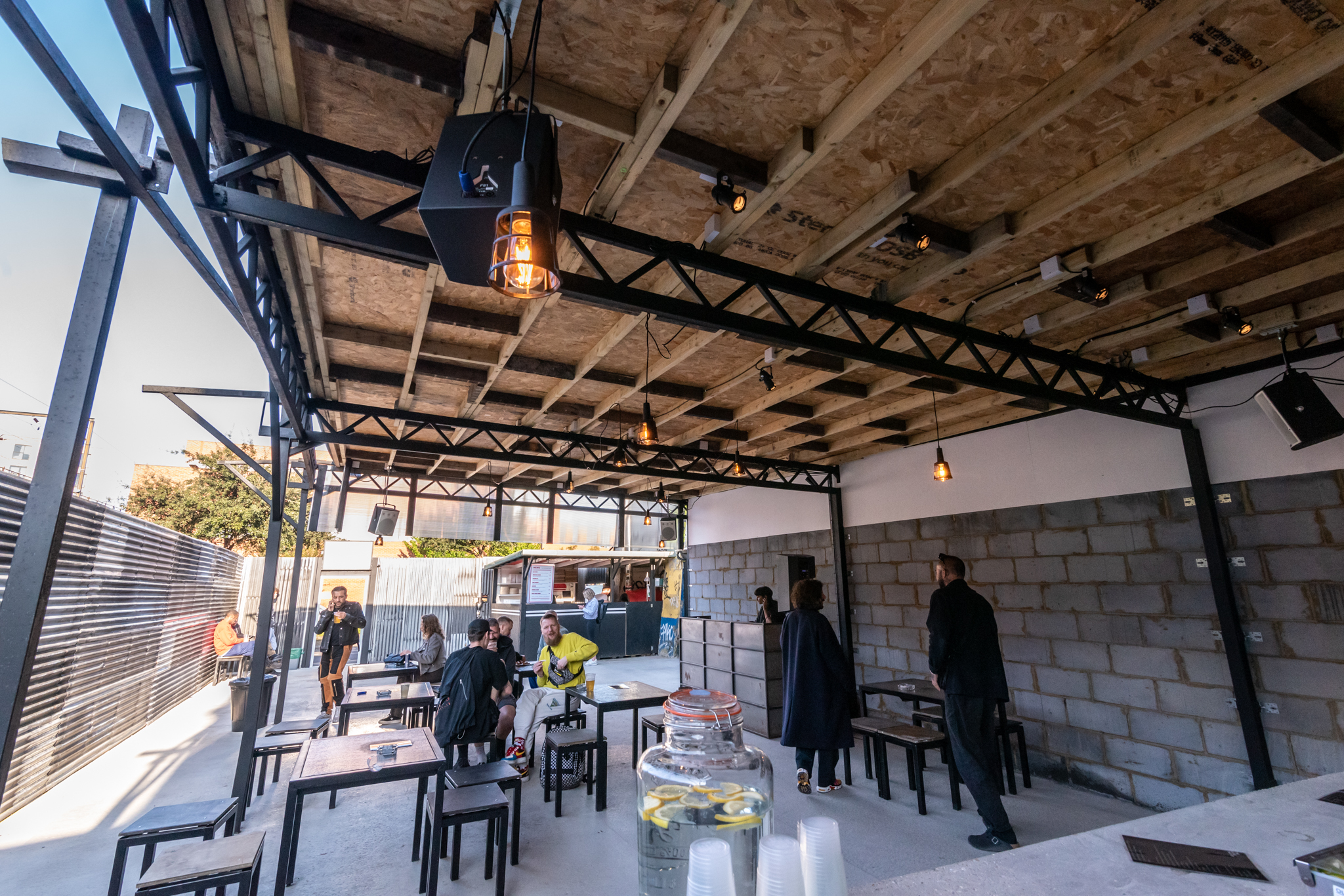 Versatile outdoor event space with modern design, ideal for gatherings and presentations.