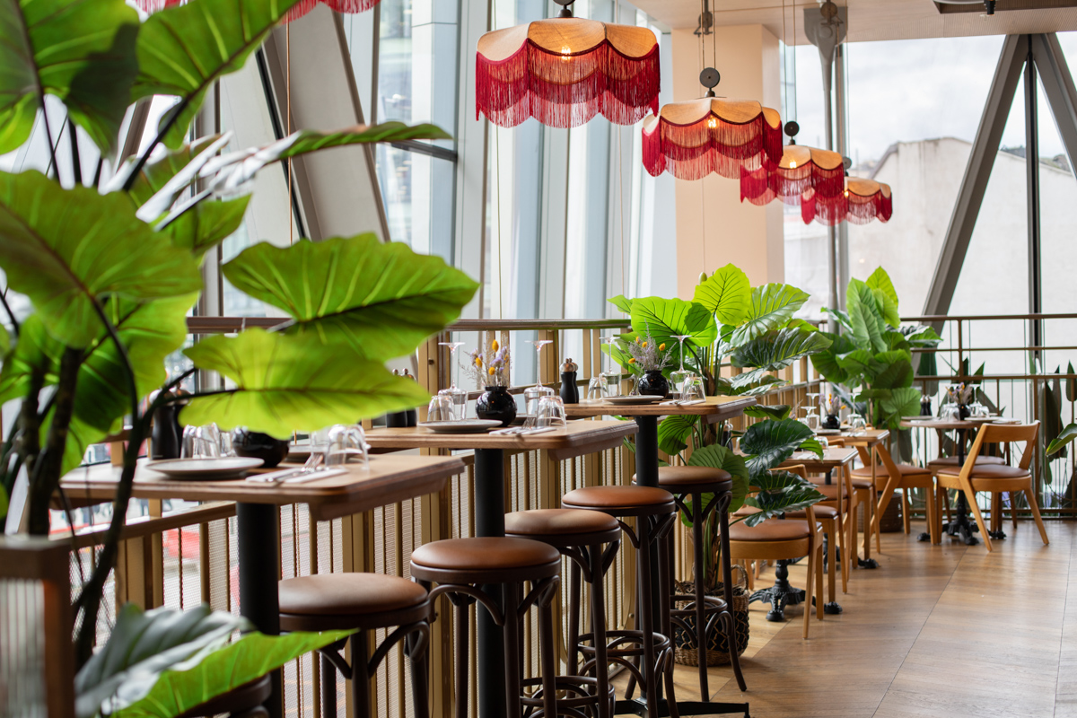 Modern event space in The Palm House with greenery, ideal for networking and meetings.