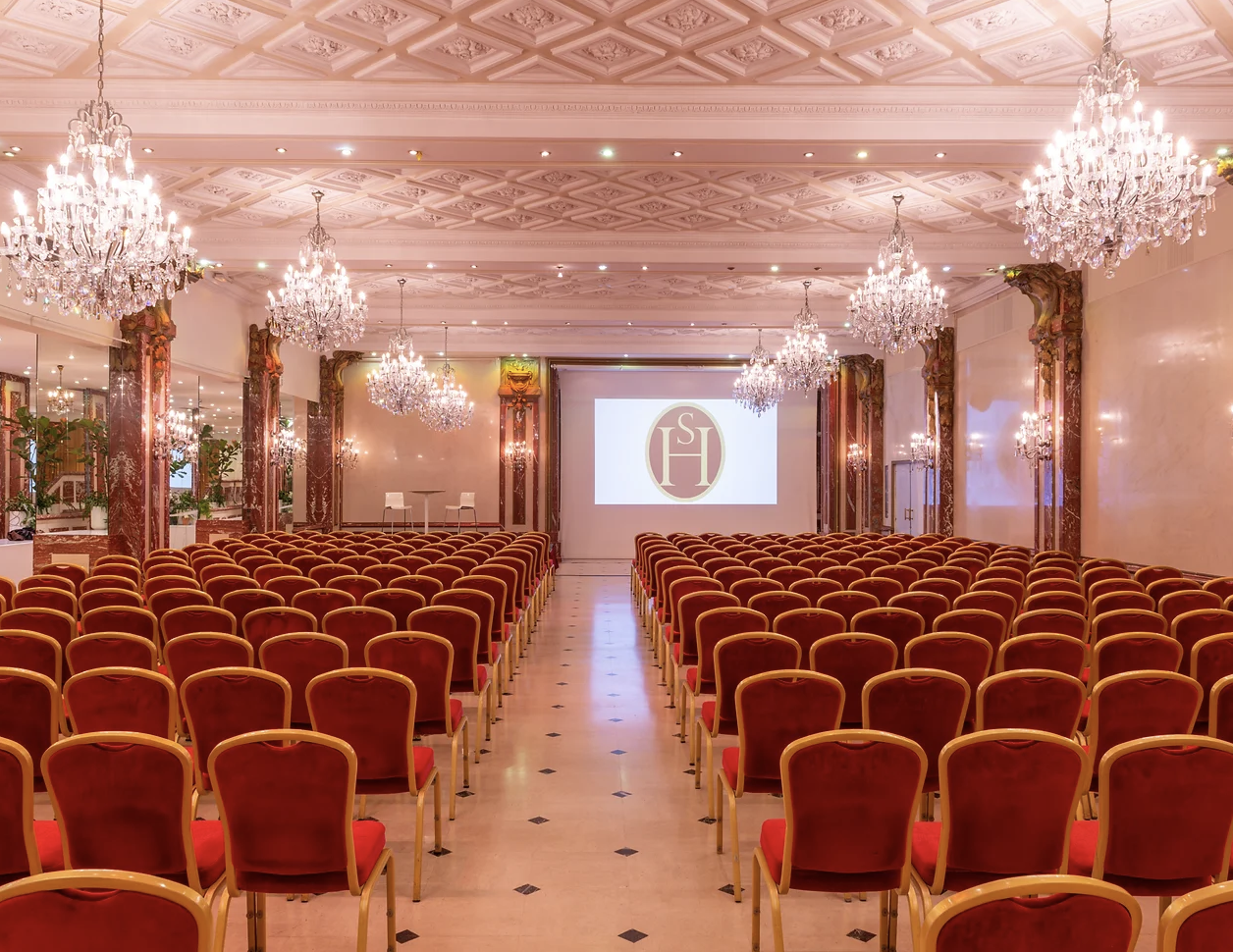 Elegant conference room with chandeliers, ideal for corporate events and presentations.