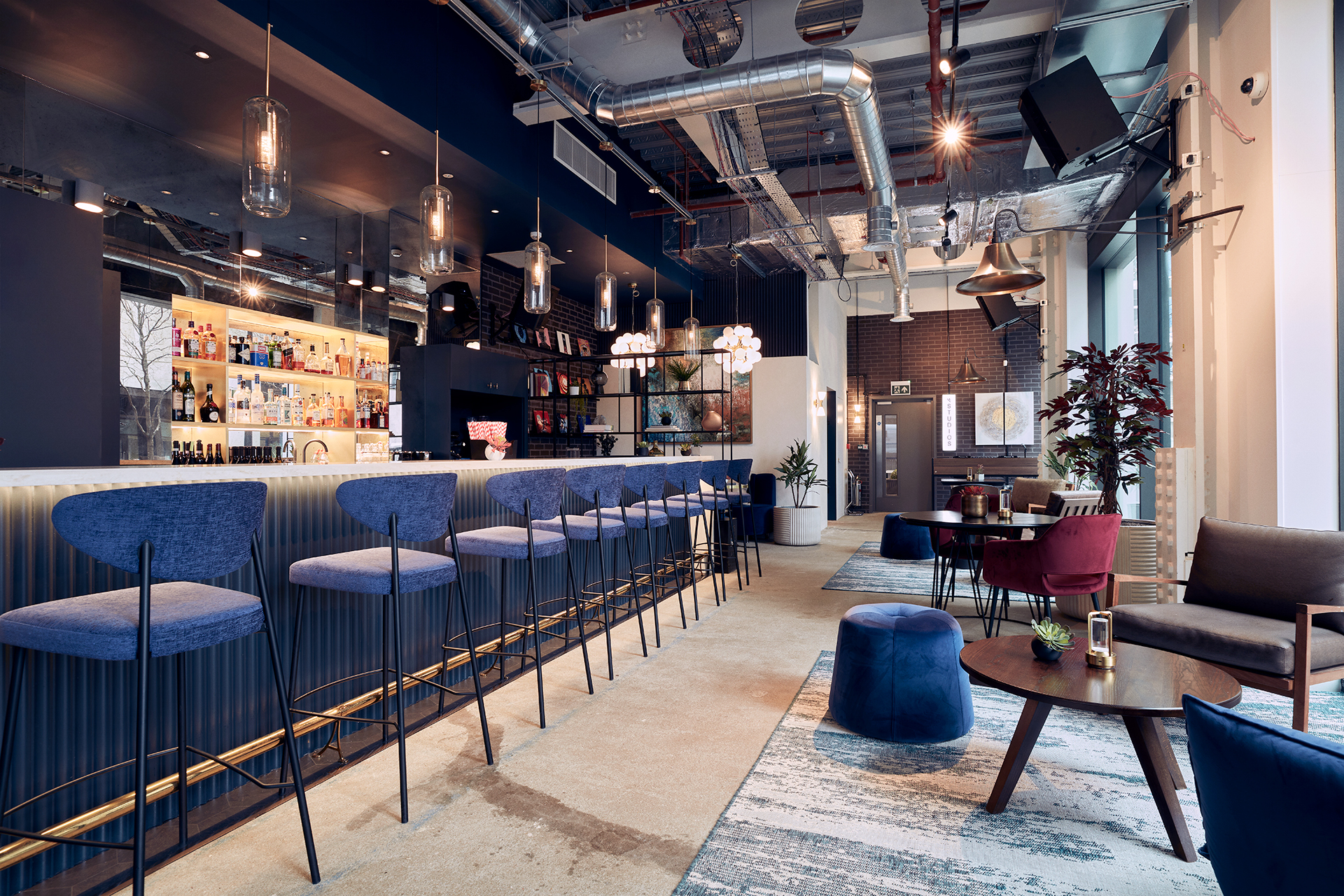 Modern Qube East venue with sleek bar, ideal for meetings and events.