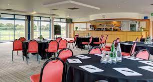 Nottingham Racecourse meeting space with round tables, ideal for events and networking.