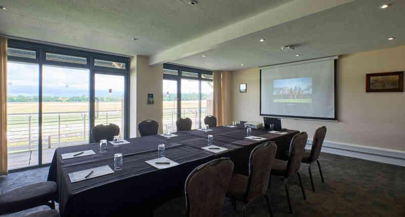 Warwick Racecourse meeting room with long table, ideal for corporate events and workshops.