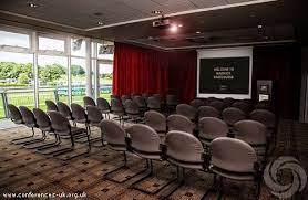 Warwick Racecourse meeting room with chairs and large screen for workshops or seminars.