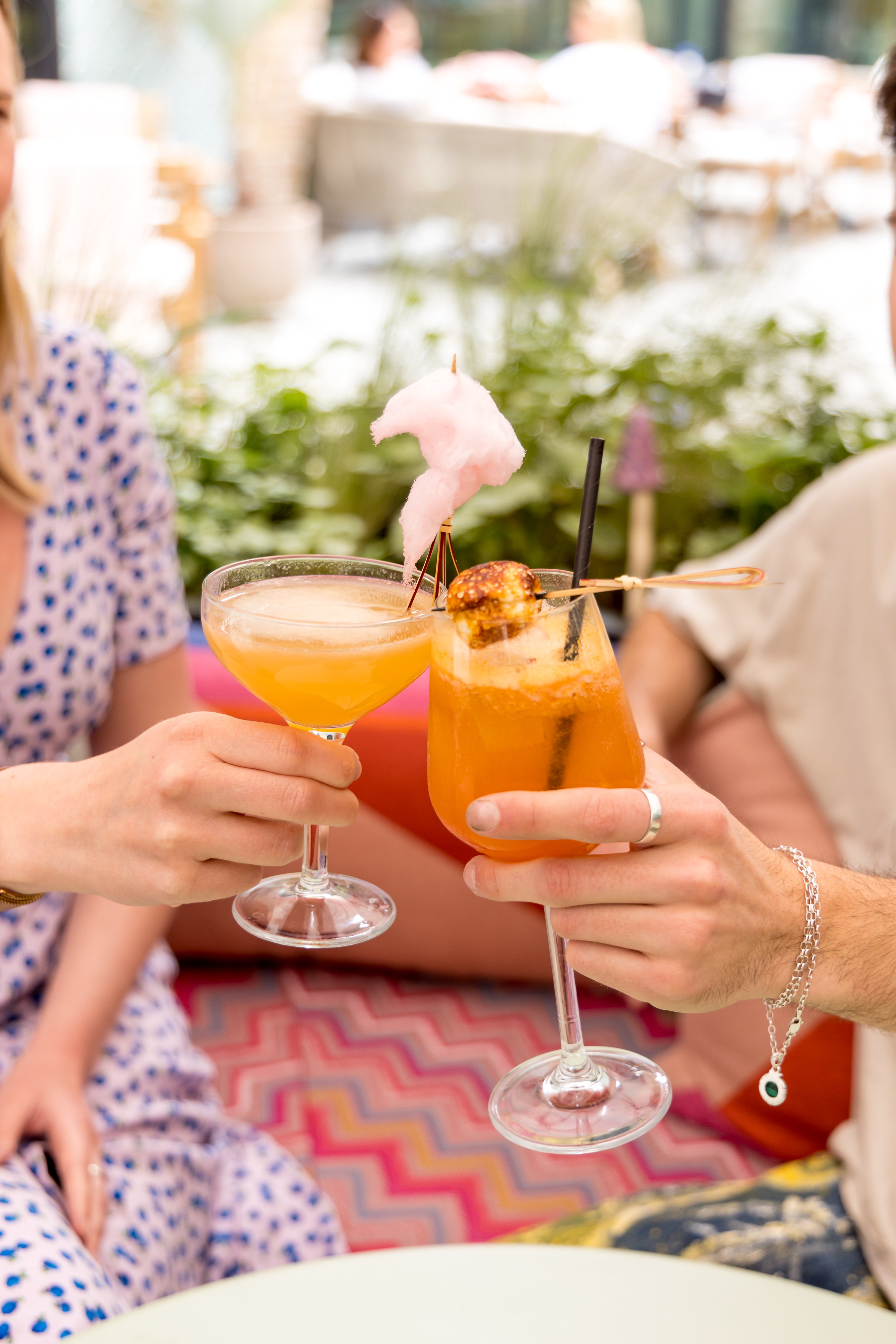 Vibrant cocktail toast in Courtyard at The Little Scarlet Door for networking events.