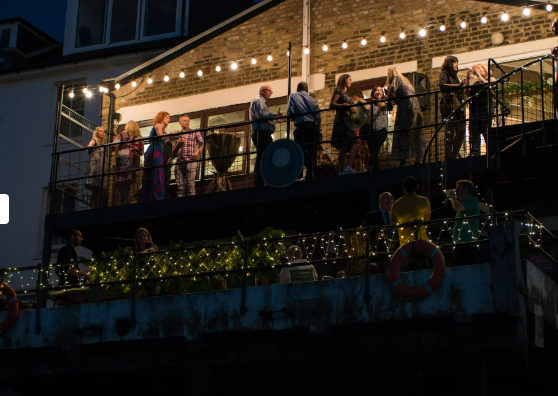 Trafalgar Rowing Centre balcony event with string lights, perfect for social gatherings.